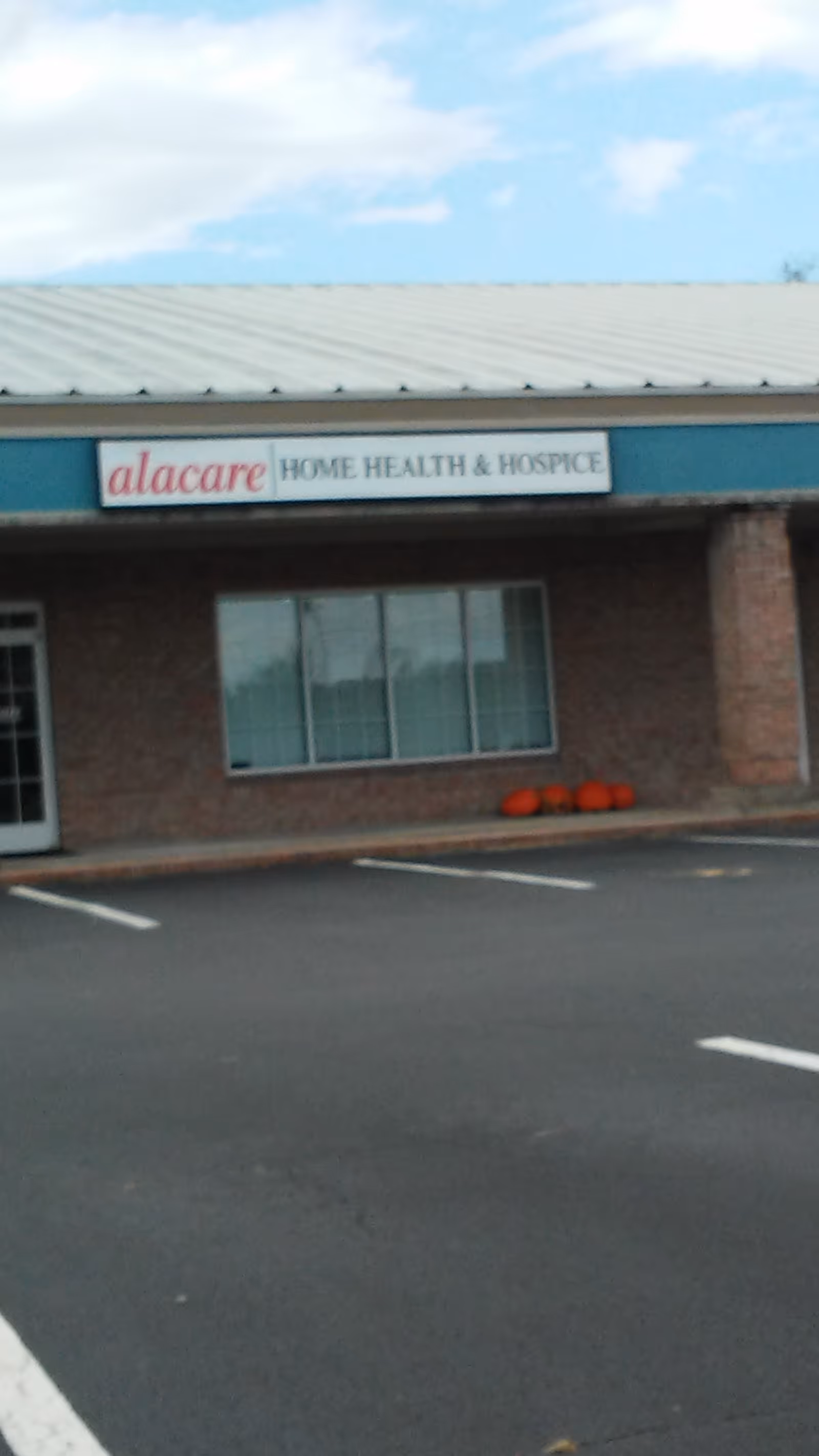 Front of a building with a sign reading alacare Home Health & Hospice.