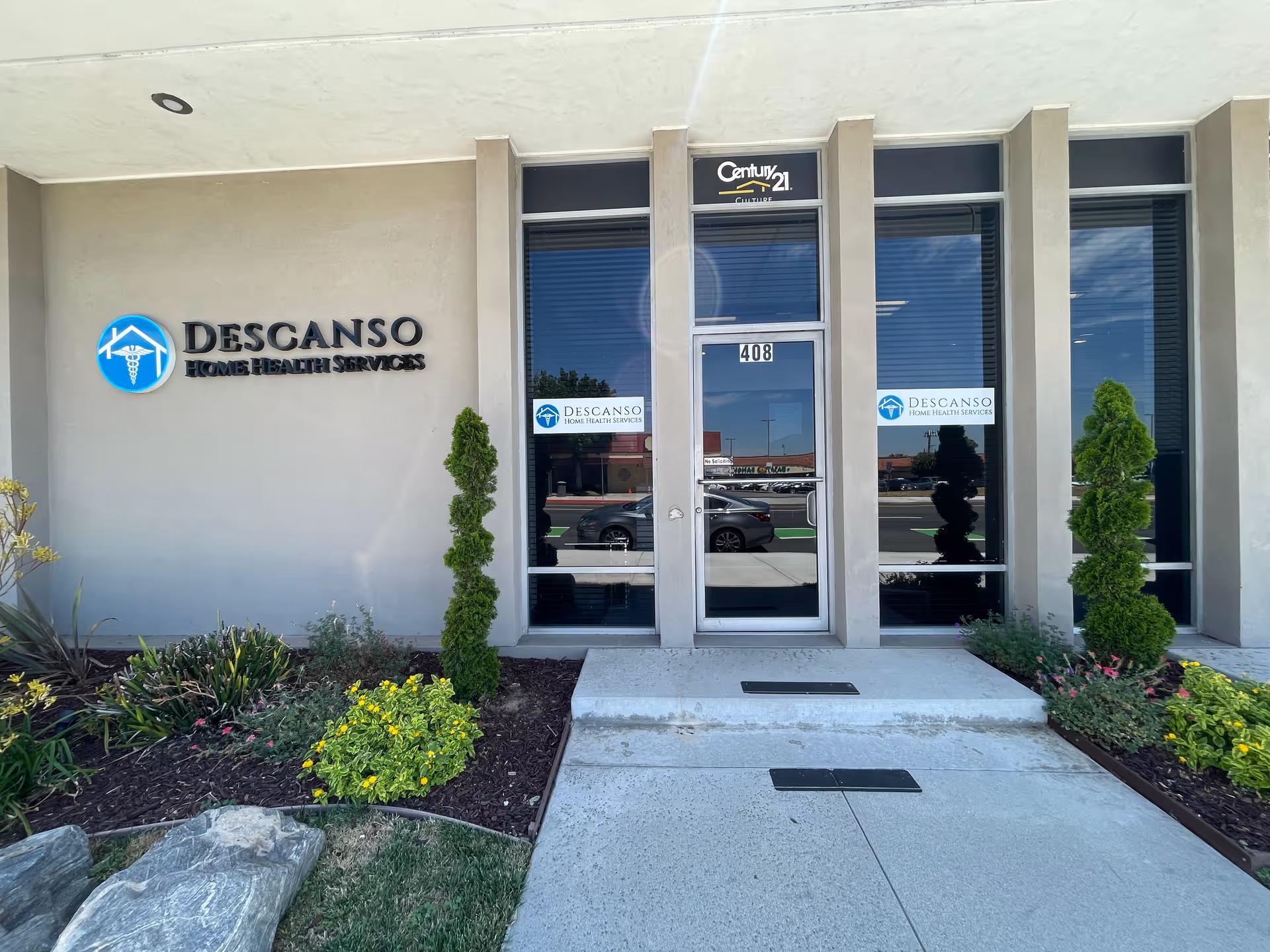 Front entrance of Descanso Home Health Services with glass doors and landscaping.