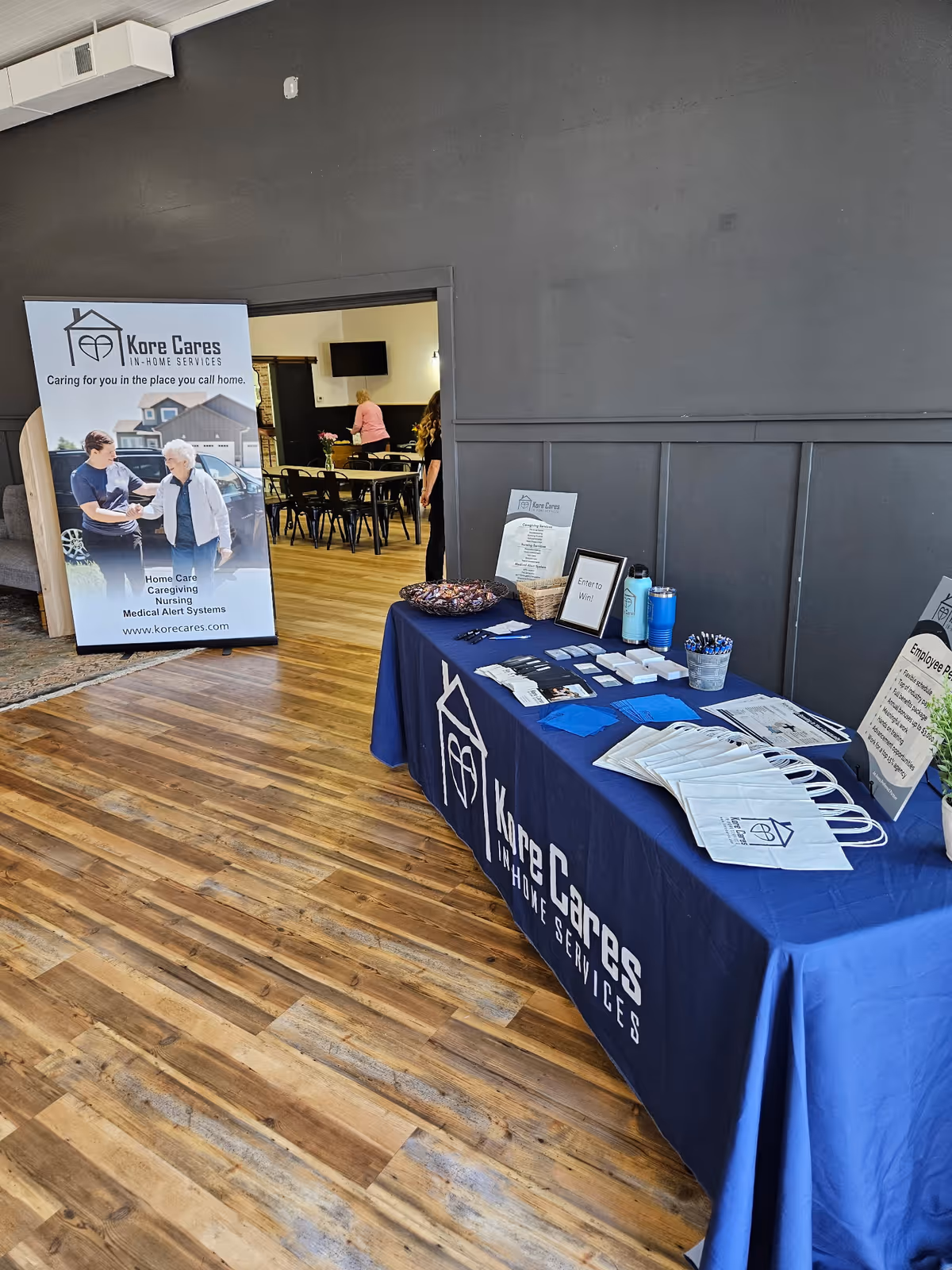 Promotional information table with Kore Cares banner in a facility lobby.