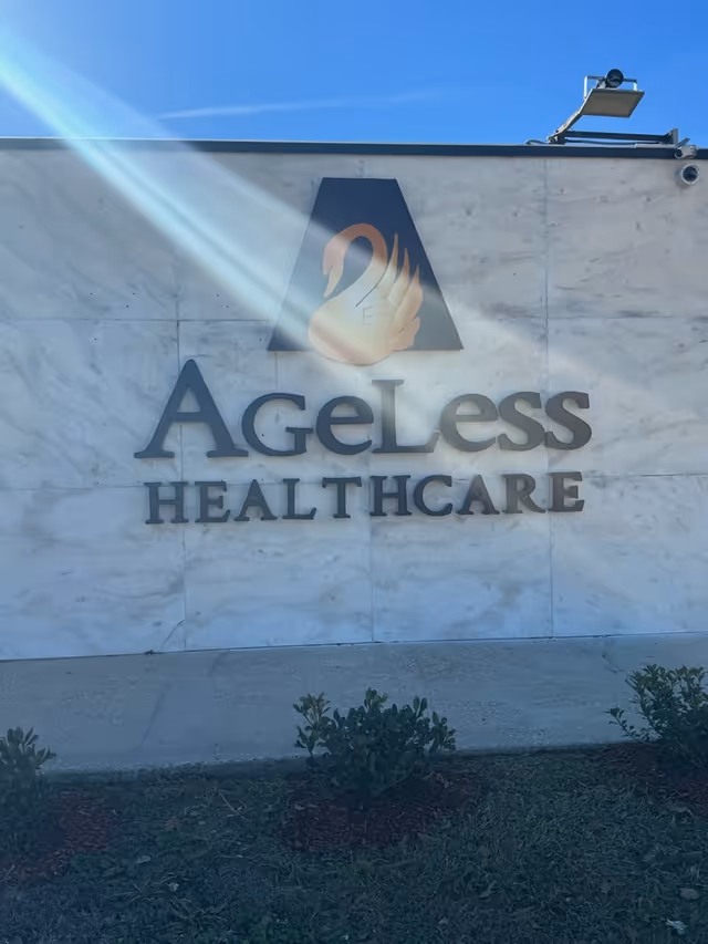 Exterior wall with Ageless Healthcare logo and large sign.