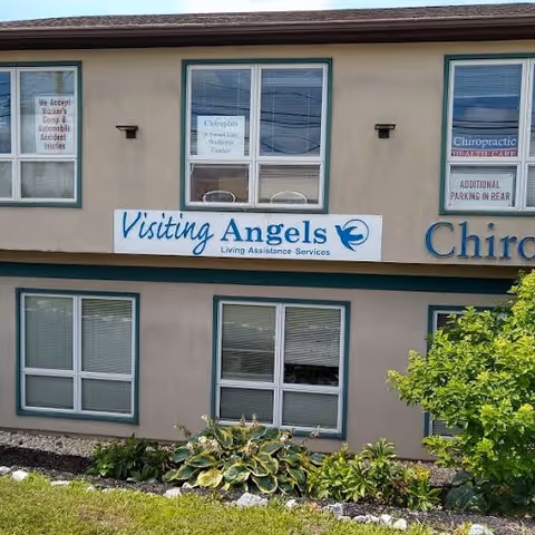 Exterior view of a senior home care center with Visiting Angels signage.