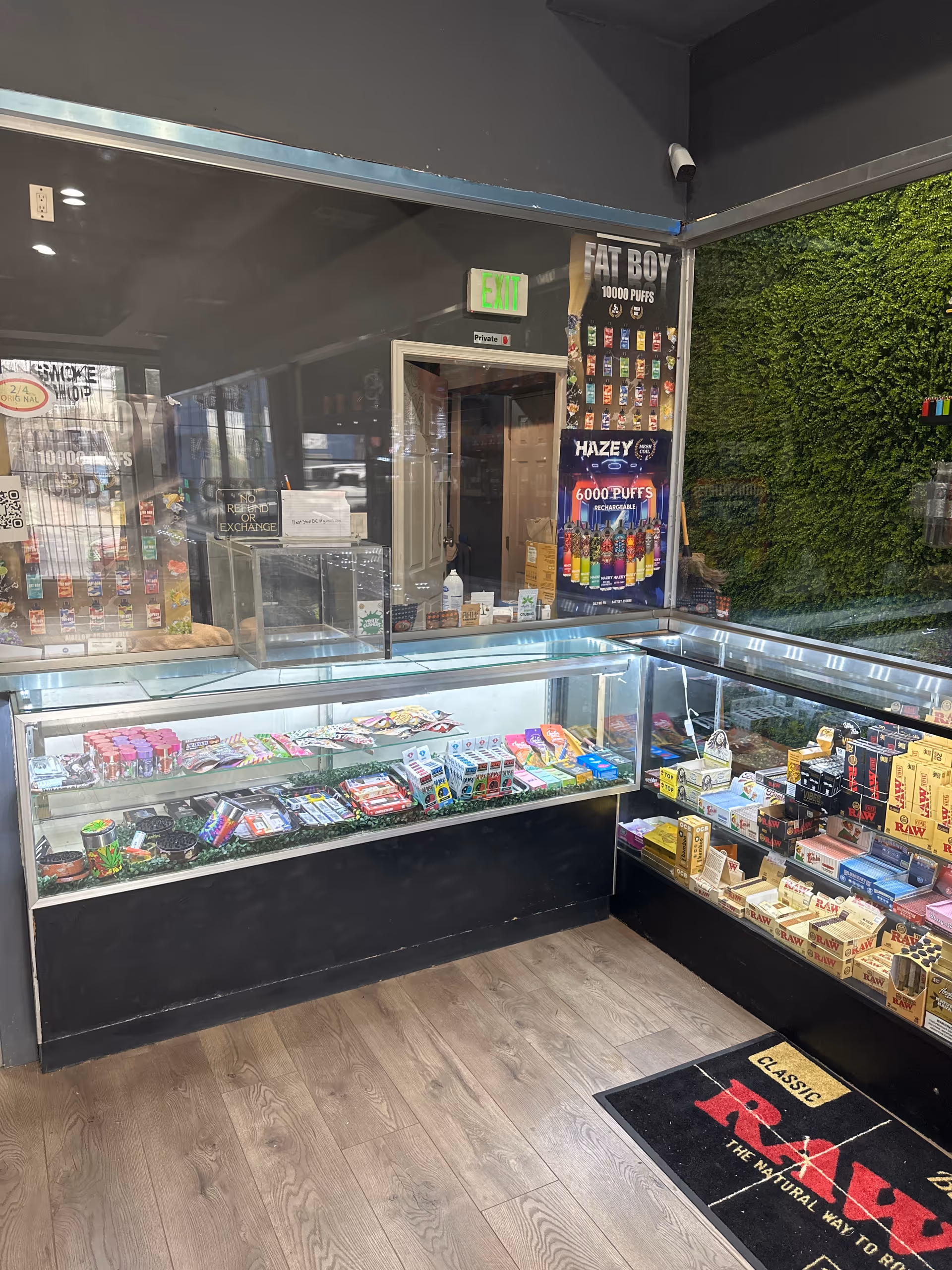 Interior of a smoke shop with glass display cases and stocked shelves.