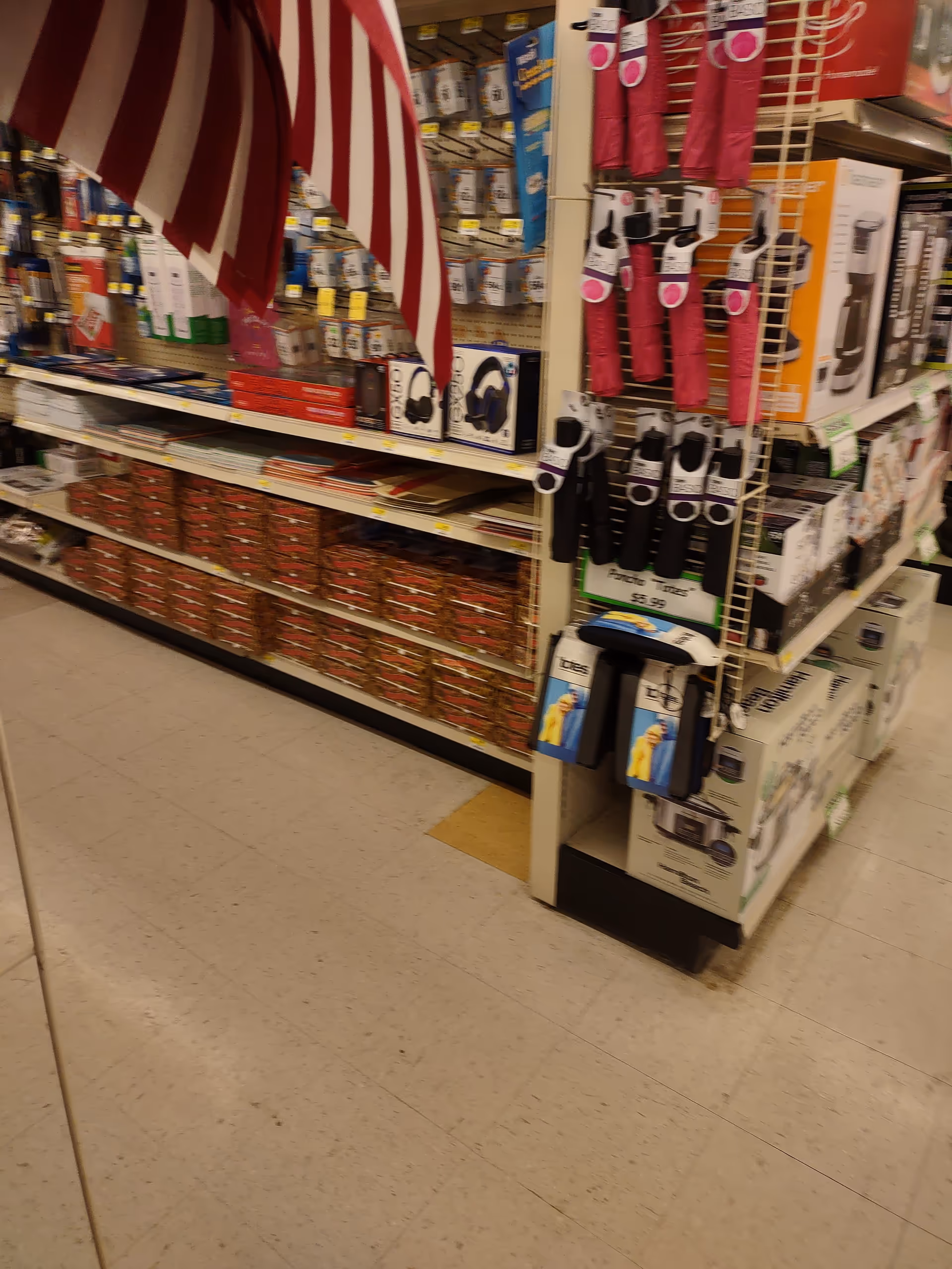 Inside Discount Drug Mart, shelves stocked with assorted products in an aisle.