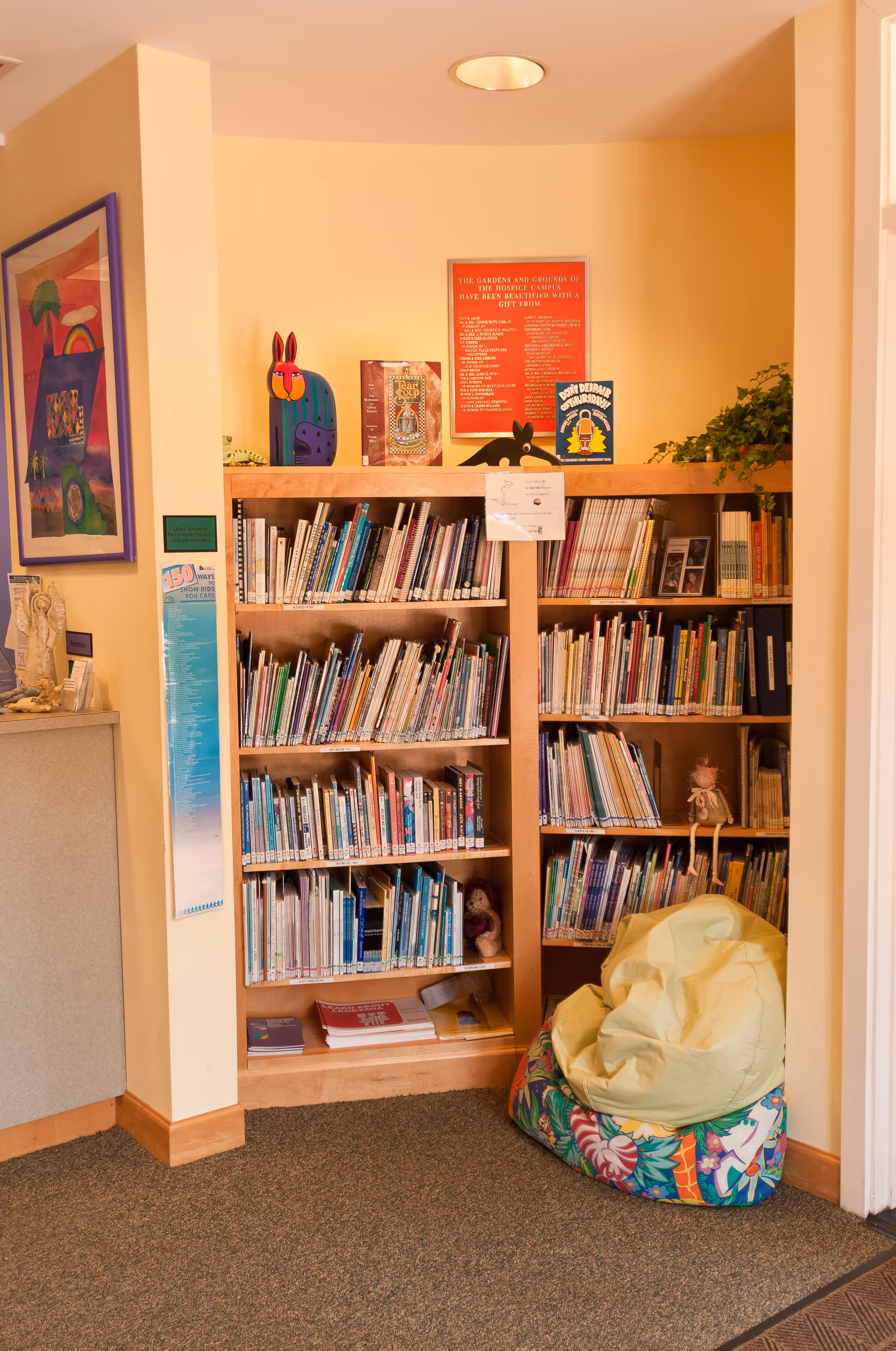 Interior children's reading nook with bookshelves and a colorful bean bag.