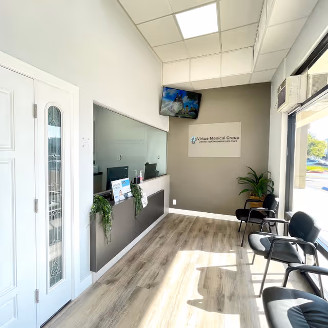 Reception area inside Virtue Medical Group Santa Ana with front desk, seating, and plants.