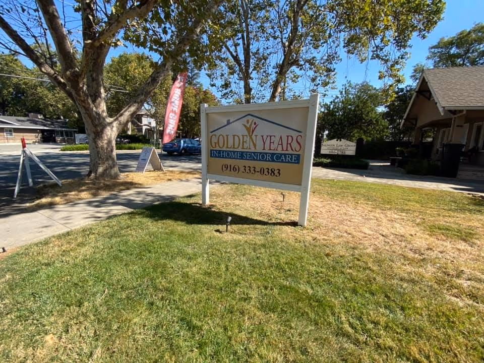 Outdoor scene with a Golden Years senior care sign on a grassy lawn.