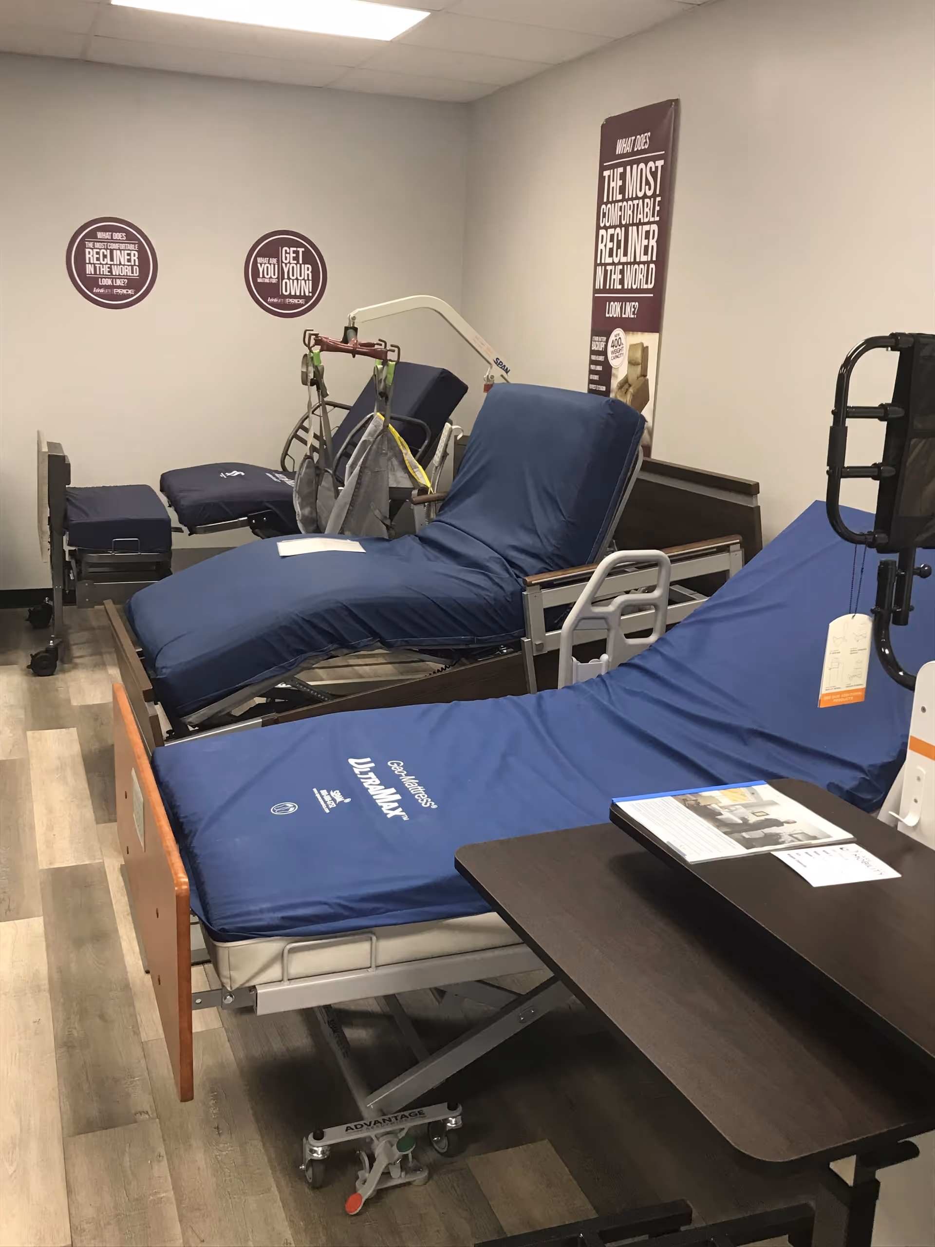 Indoor room displaying blue-covered medical recliners and mobility equipment.