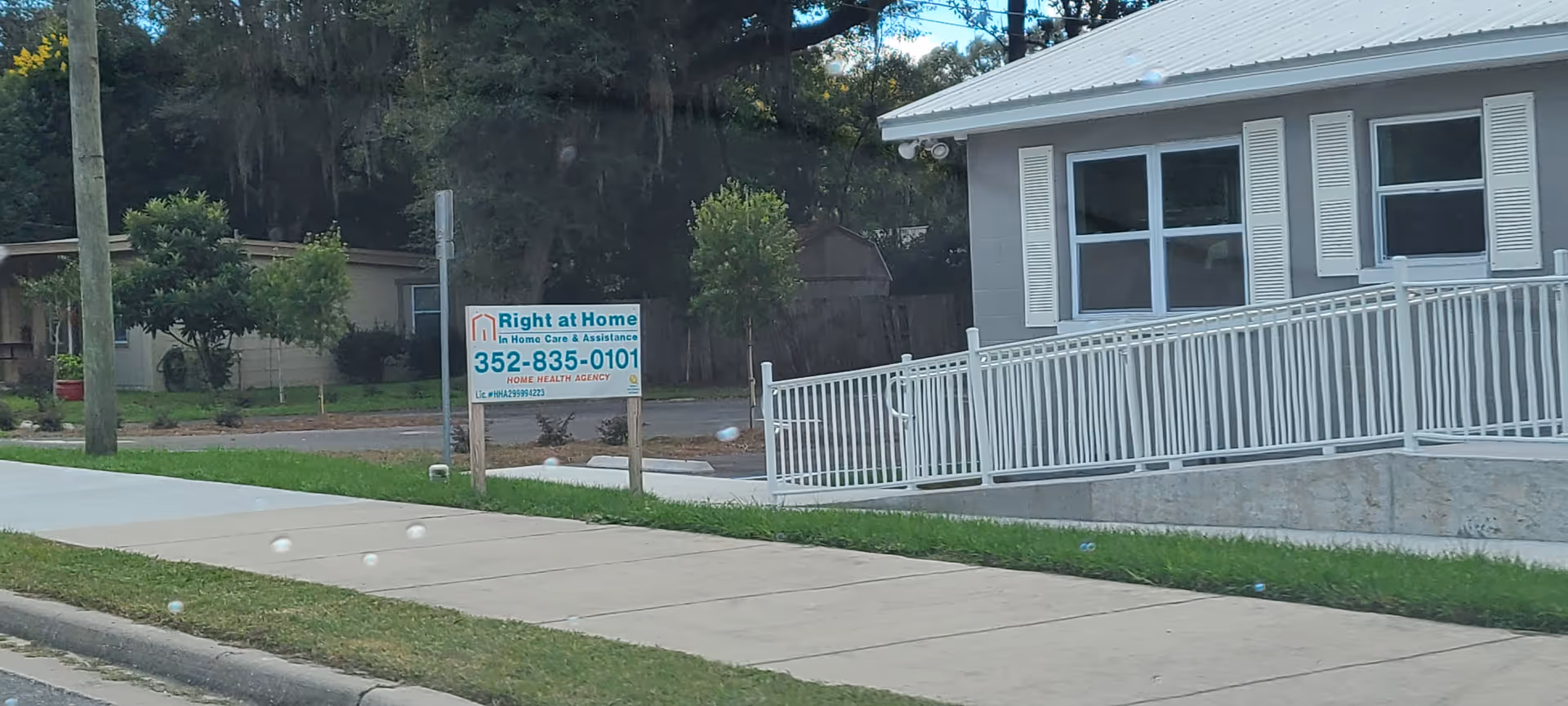 Front exterior of Right at Home facility with ramp and sign.