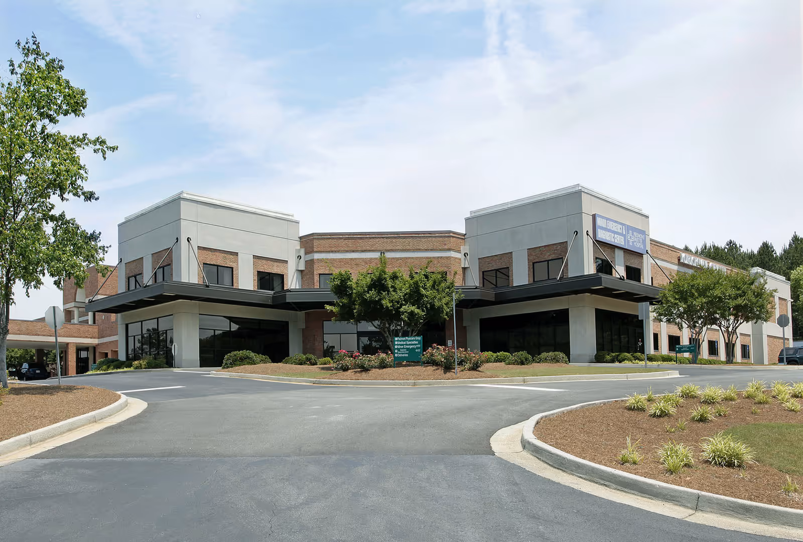 Compassus senior living center exterior with curved driveways and landscaped entrance.