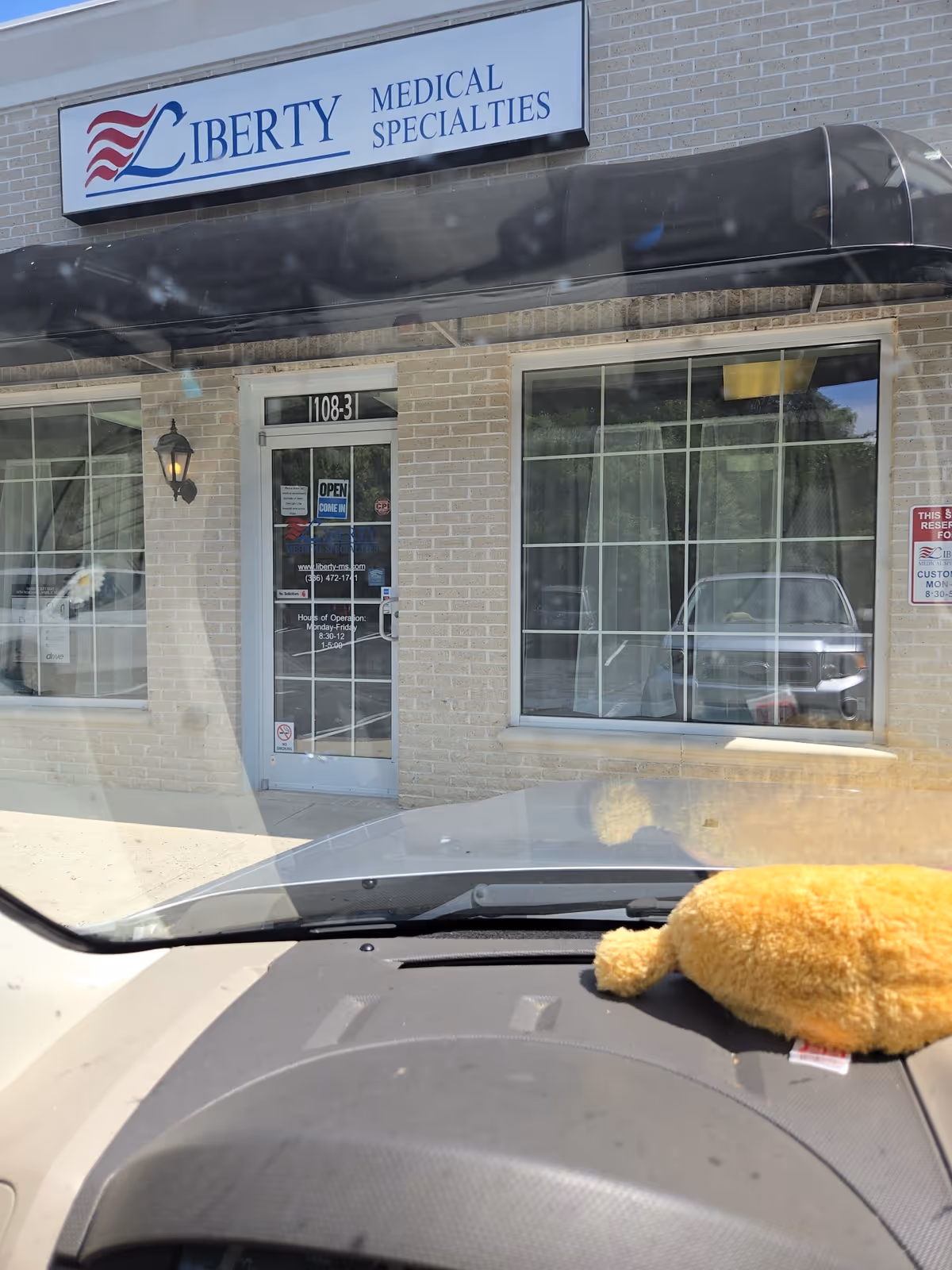 Front exterior of Liberty Medical Specialties building with sign and glass door