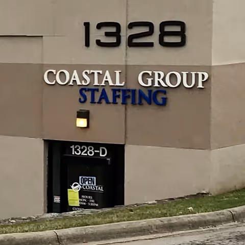 Exterior building facade with 1328 address and Coastal Group Staffing sign.