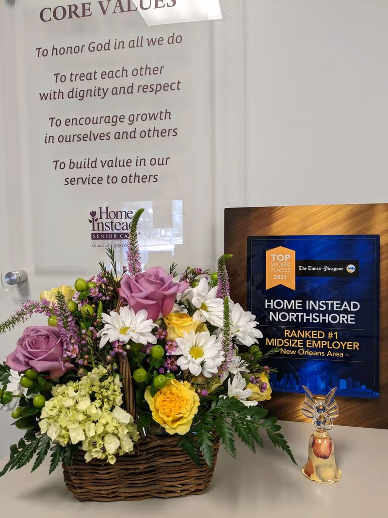 Interior reception area with a flower basket and Home Instead sign plaque