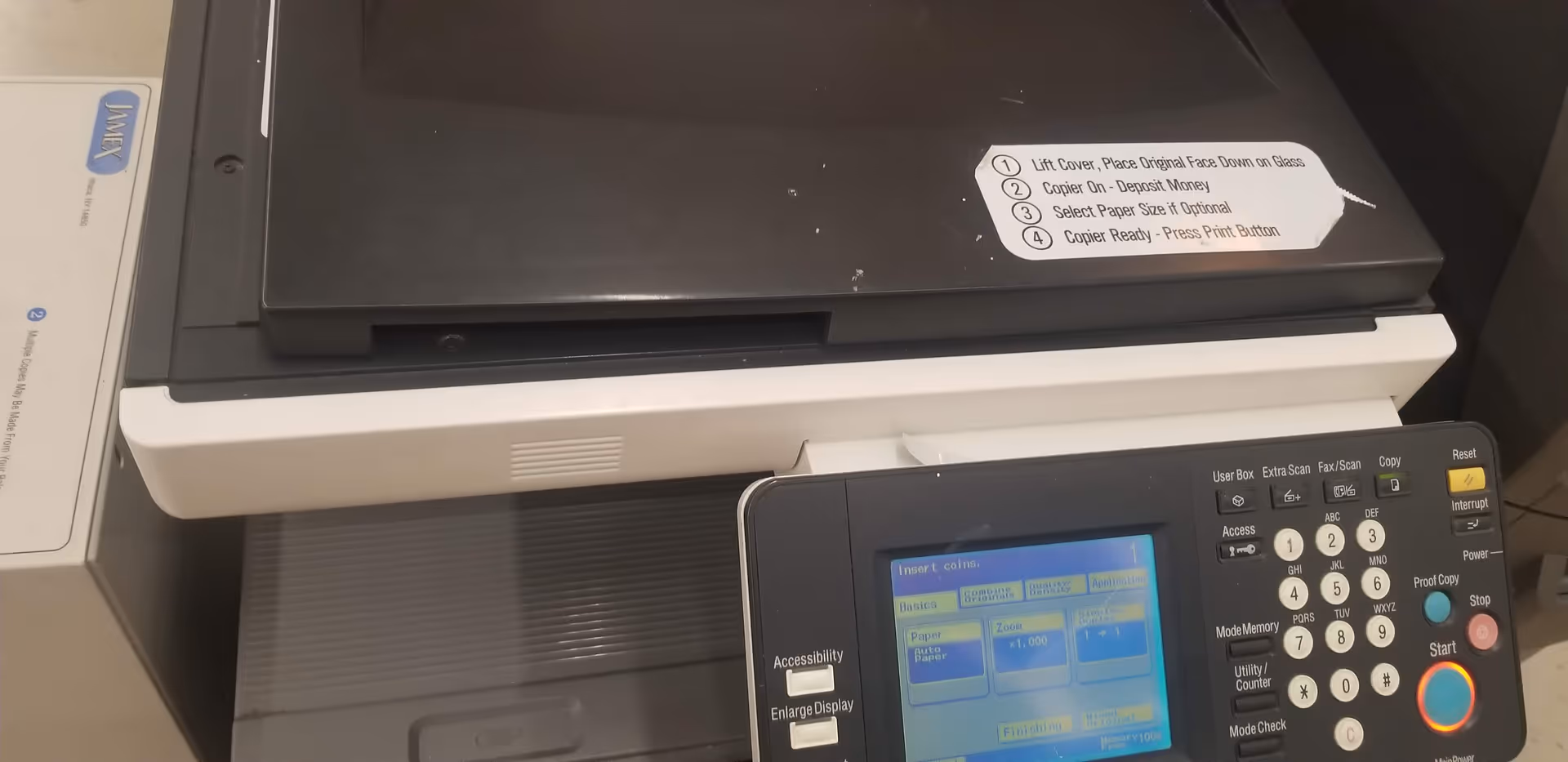 Printer and copier on a counter inside Discount Drug Mart facility.