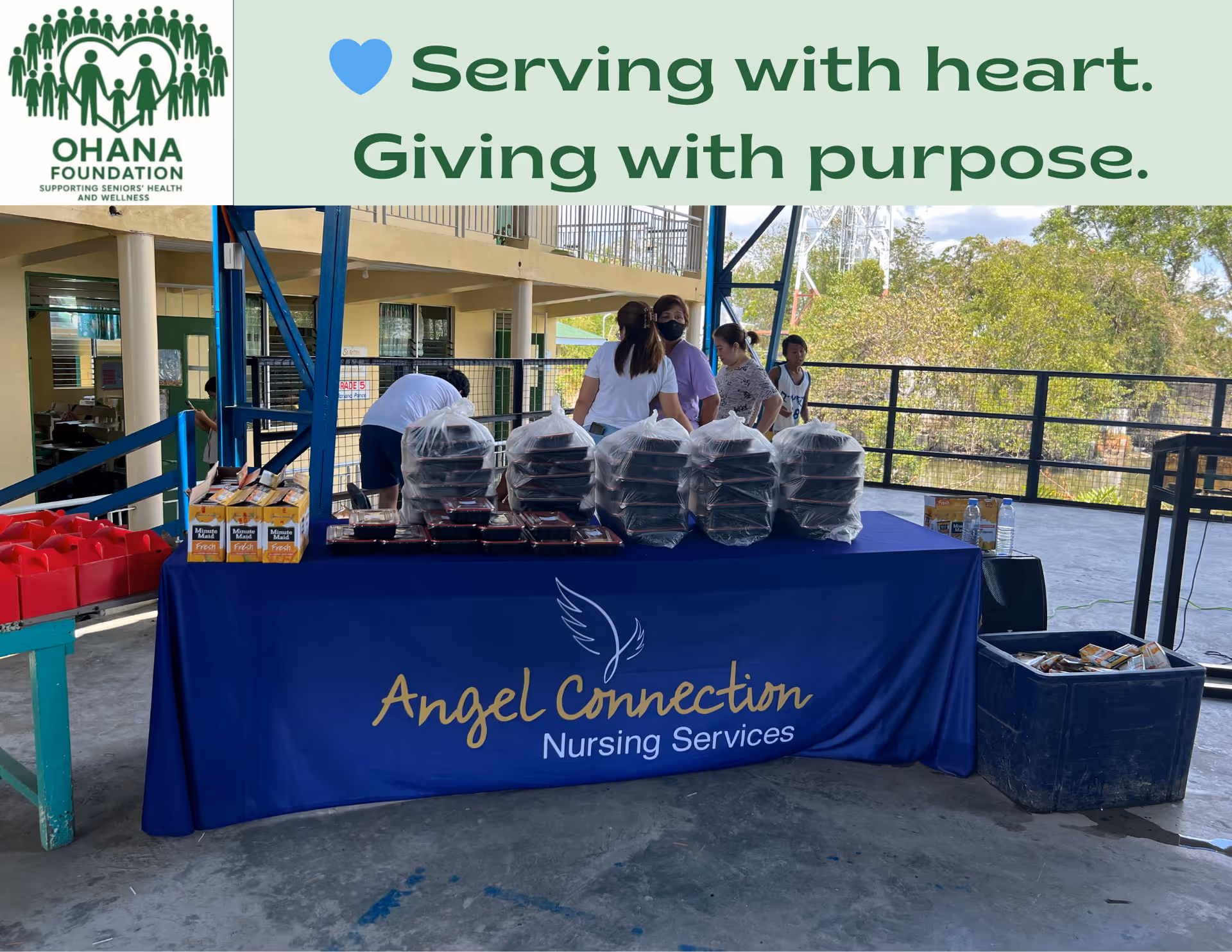 Outdoor event at Angel Connection Nursing Services with a table of supplies and staff.