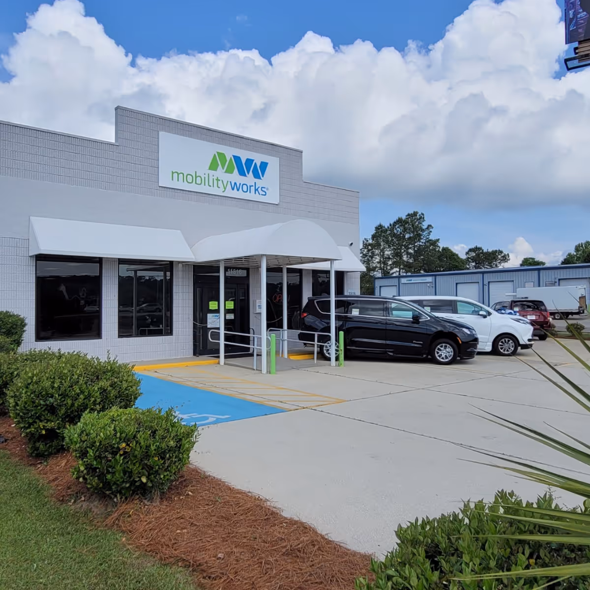 MobilityWorks storefront with entrance canopy and parked cars along the front parking lot.
