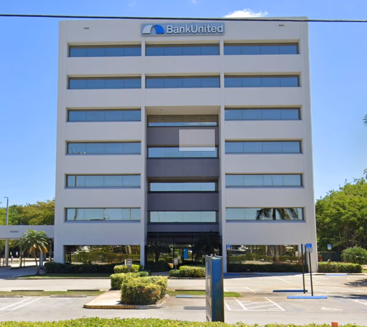 A multi-story modern office building with a BankUnited sign and glass windows.