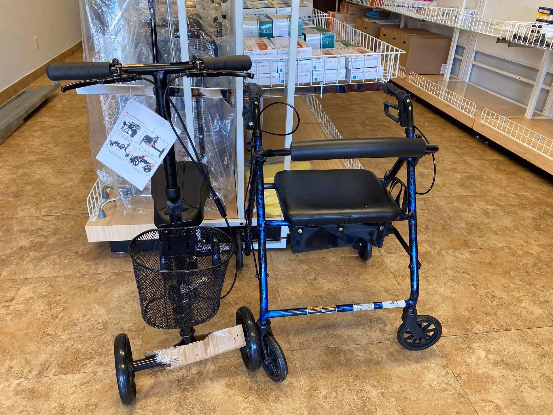 Blue rollator with seat and front basket in a storage room with shelves.