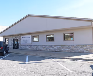 Exterior view of a single-story SSM Health at Home facility with stone veneer and sign.