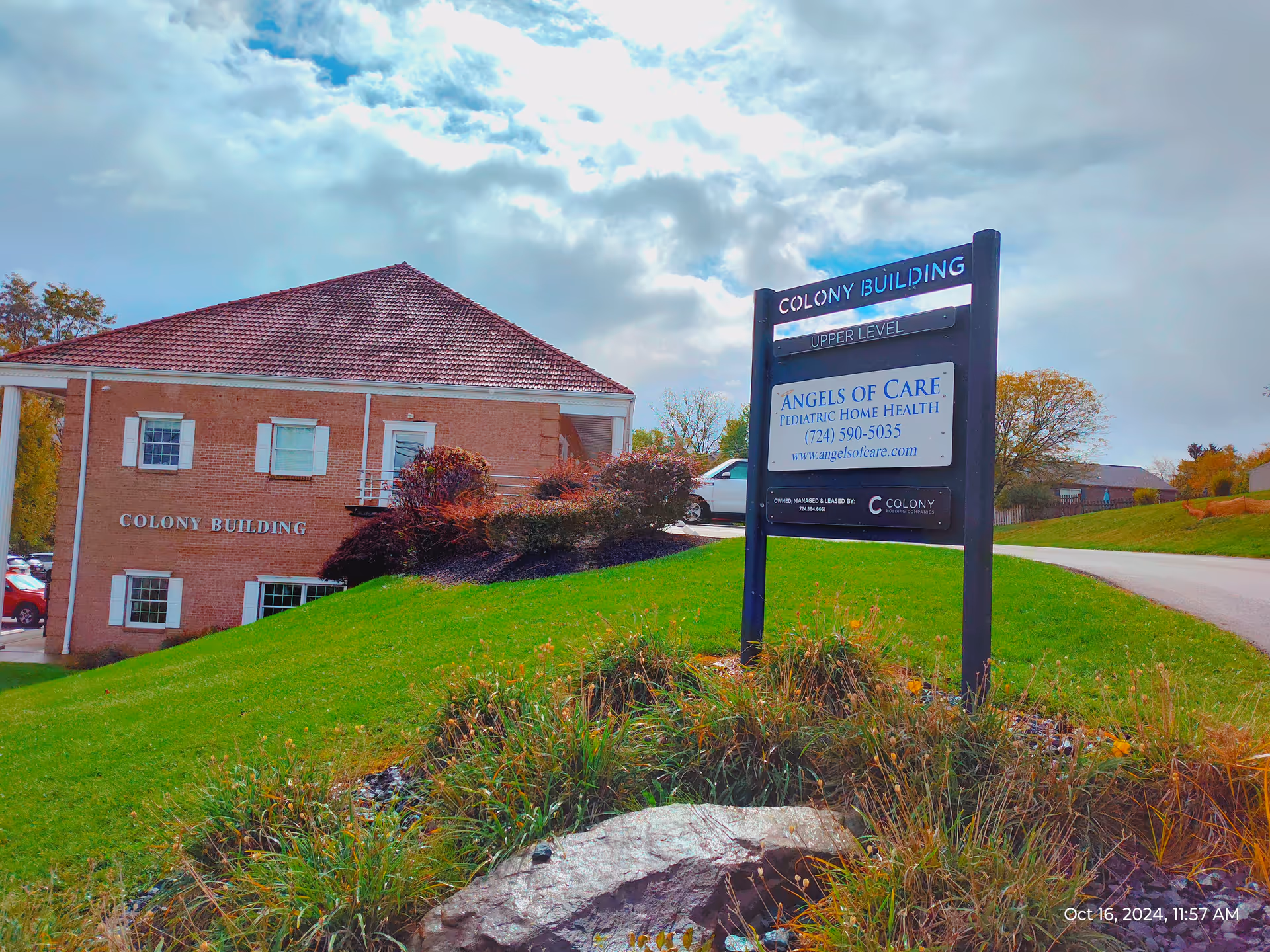 Brick building labeled Colony Building with a sign for Angels of Care pediatric home health.