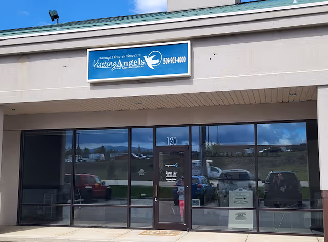 Exterior view of Visiting Angels Senior Home Care storefront with large glass doors.