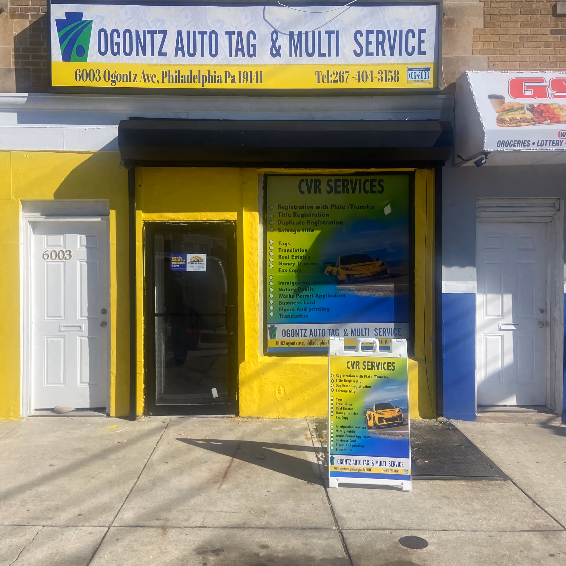 Yellow storefront with auto service signs and a doorway along Ogontz Avenue