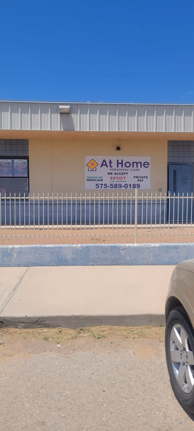 Front of a facility with an At Home Personal Care Services sign