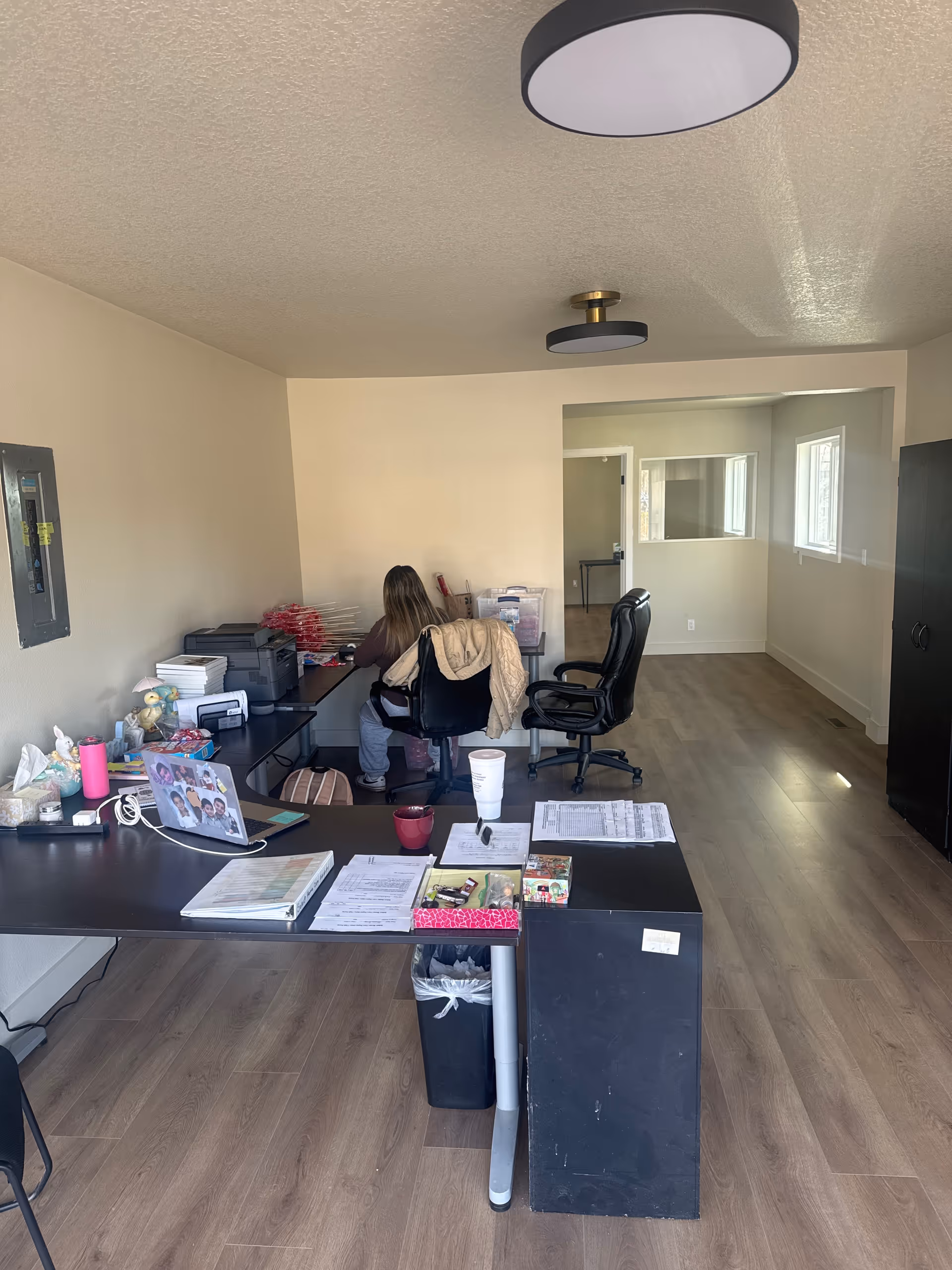 Office workspace inside Select Home Care Portland with a person seated at a desk.