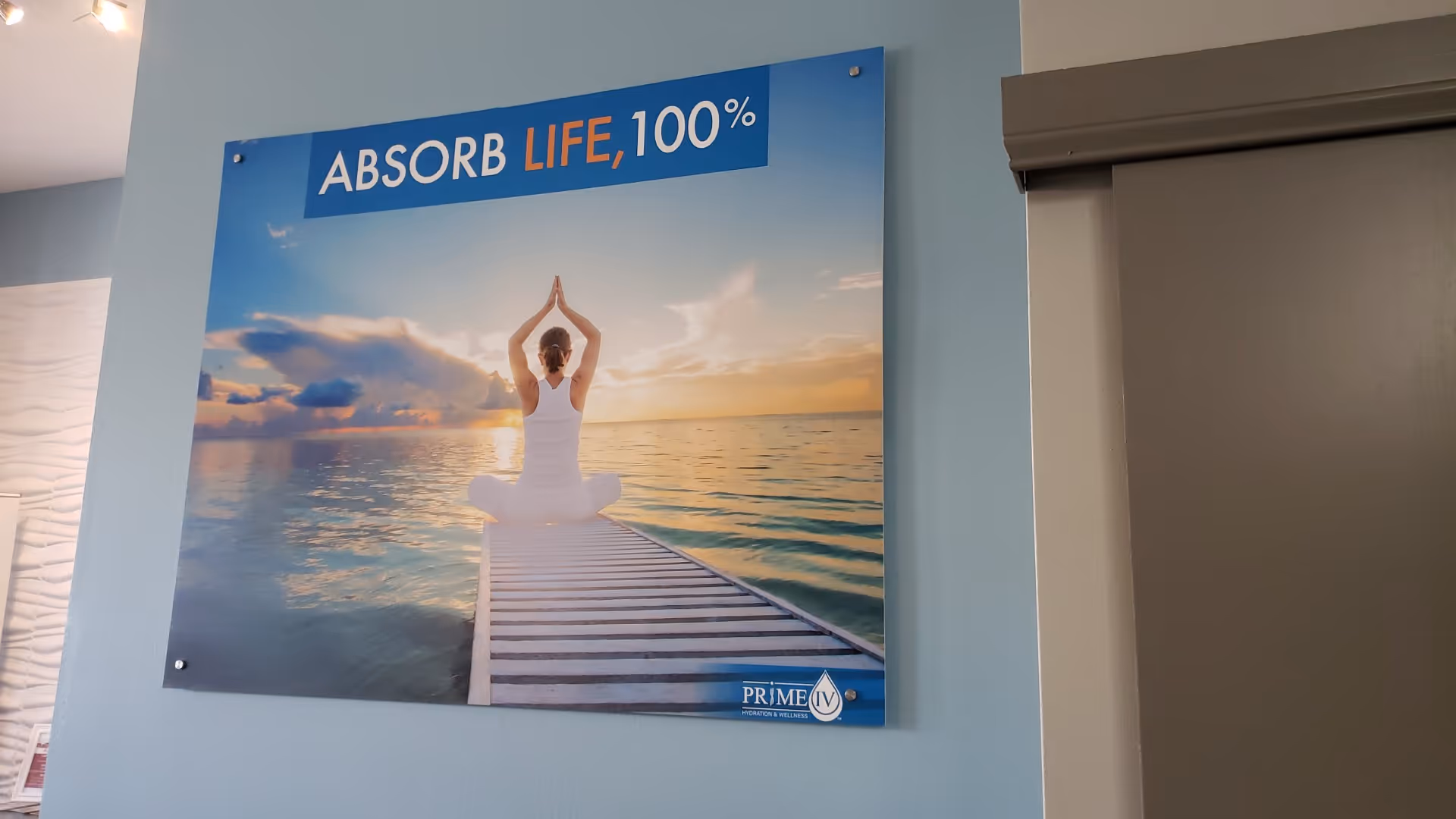 Interior wall features a large poster showing a person meditating on a dock at sunset.