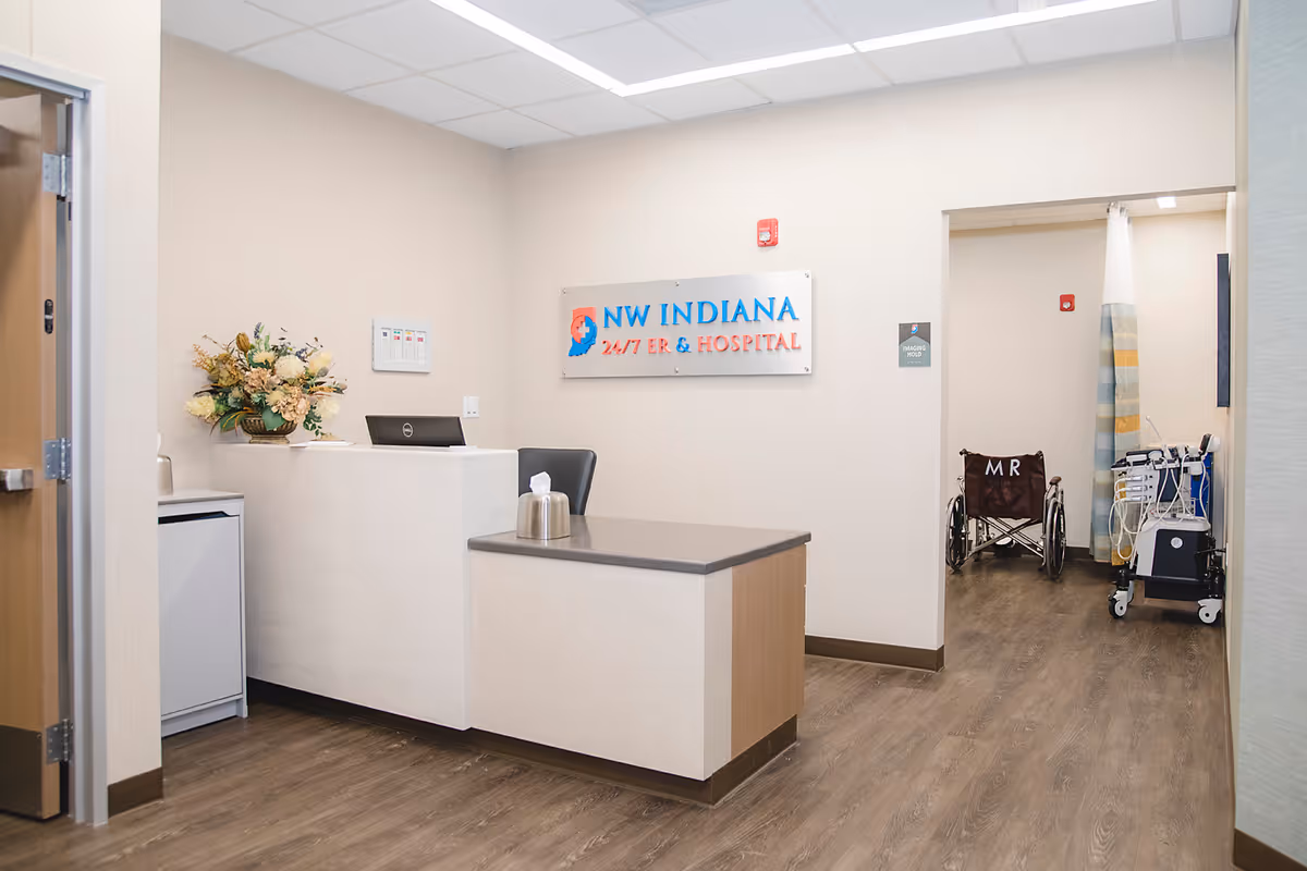 Front desk in a hospital lobby with NW Indiana ER & Hospital sign.