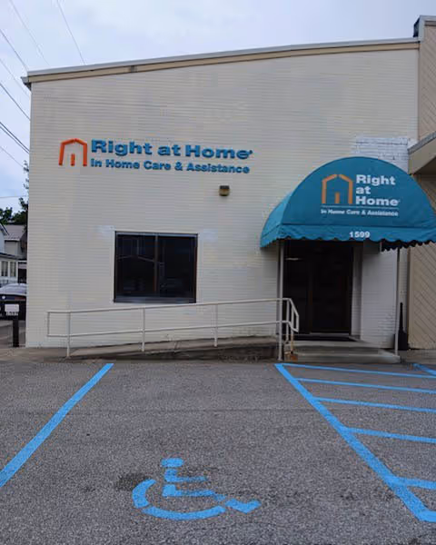 Exterior view of Right at Home facility with wheelchair-accessible entrance and blue awning