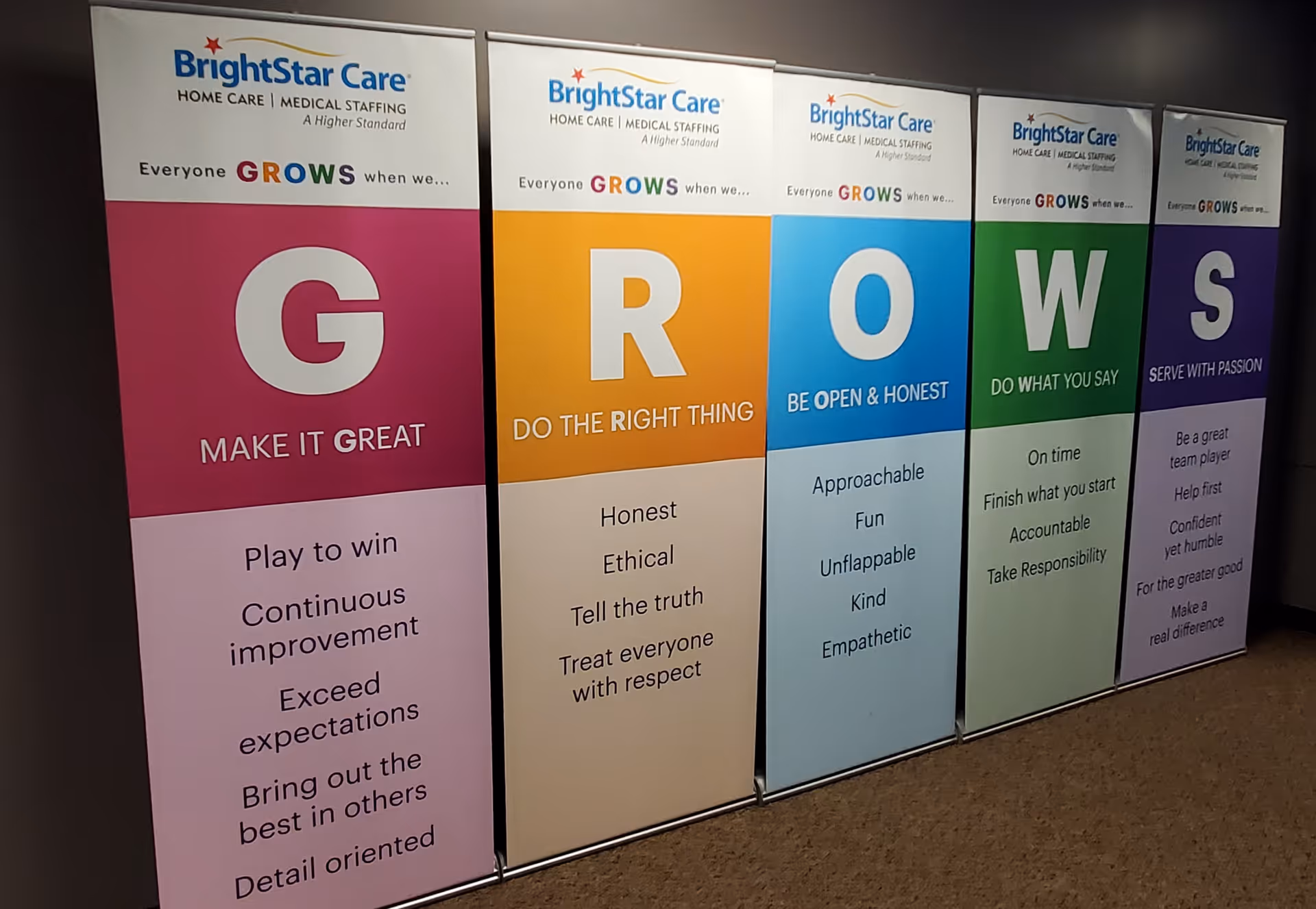 Row of BrightStar Care banners displayed in a hallway interior.