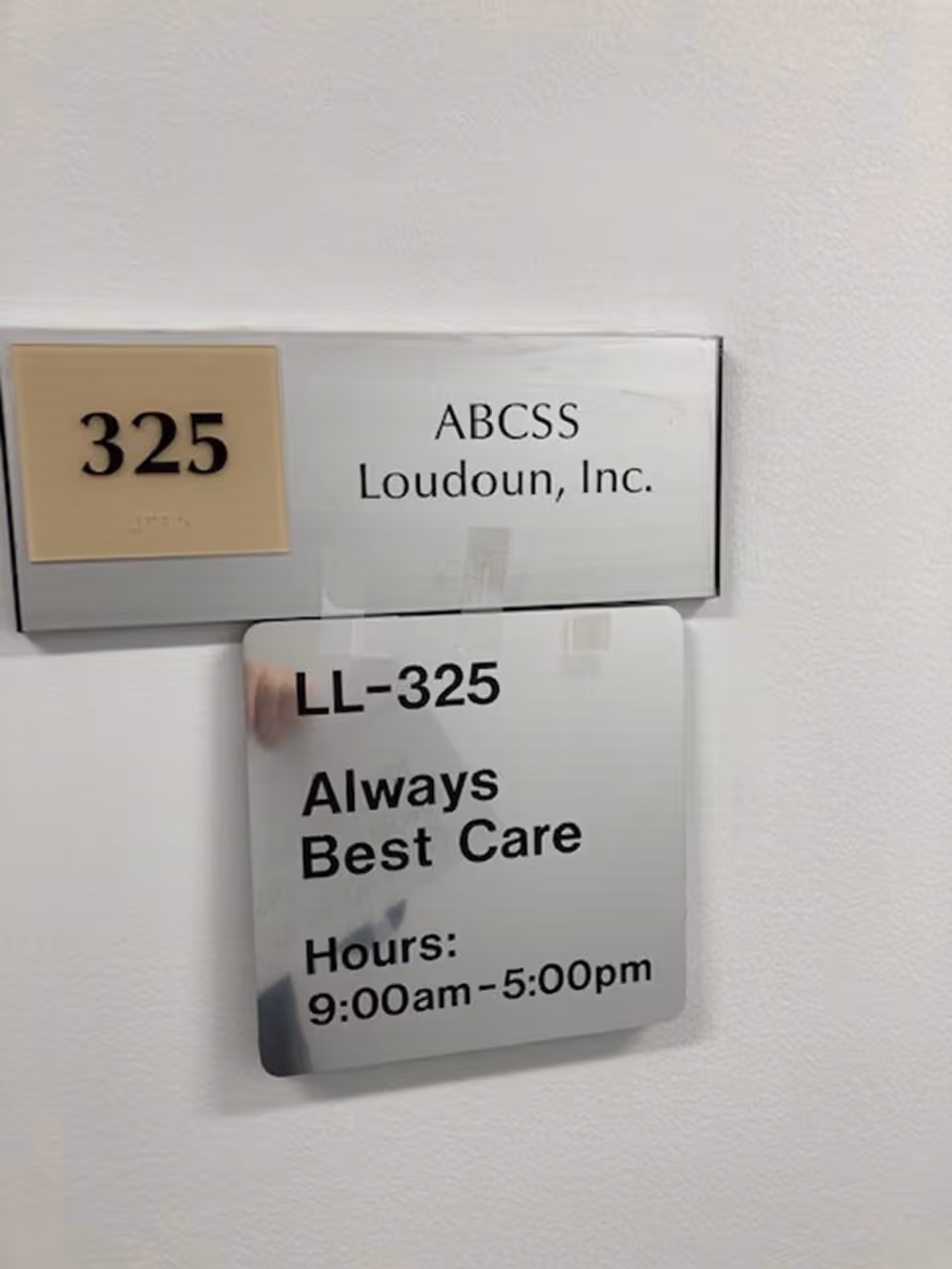 Interior hallway sign on wall showing ABCSS Loudoun, Inc. and LL-325.