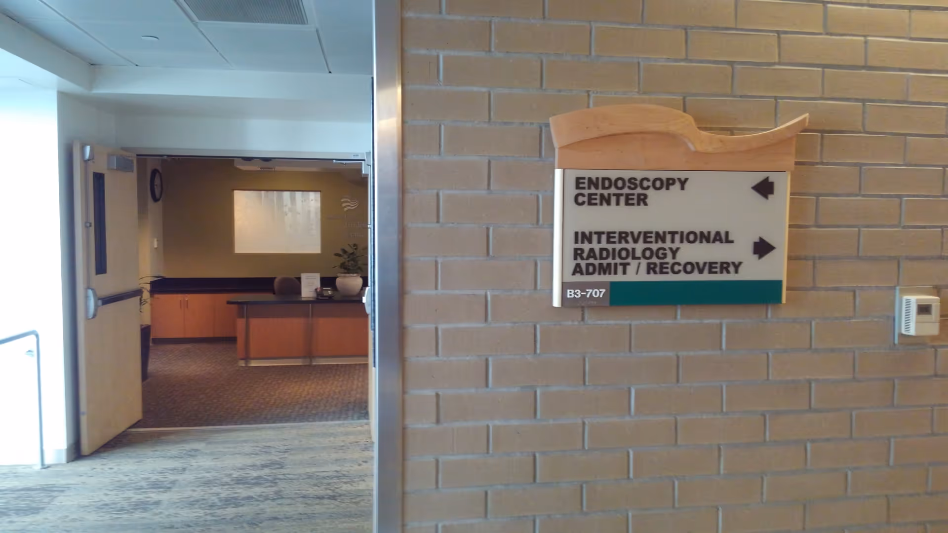 Indoor hospital corridor featuring Endoscopy Center and Interventional Radiology sign.