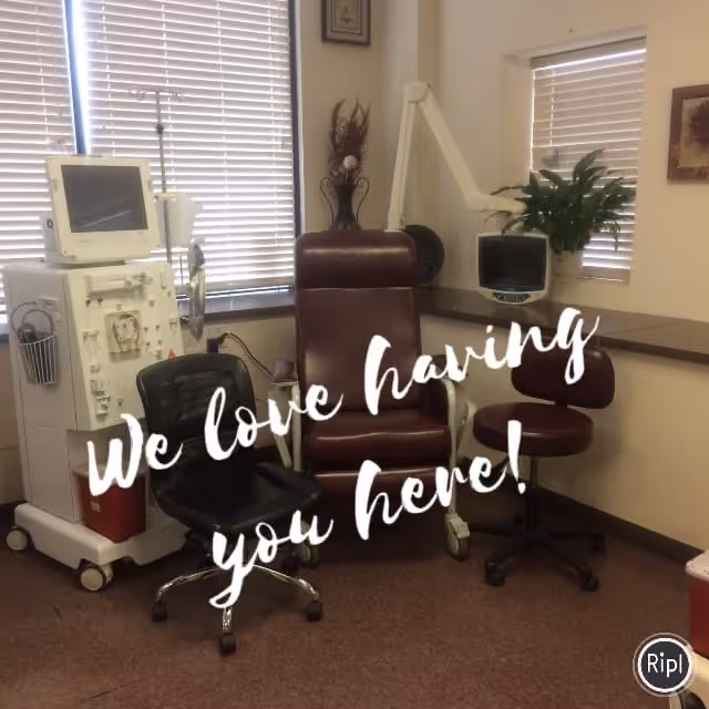 Dialysis treatment area with chairs, a medical machine, monitor, plant, window blinds, and overlay text.