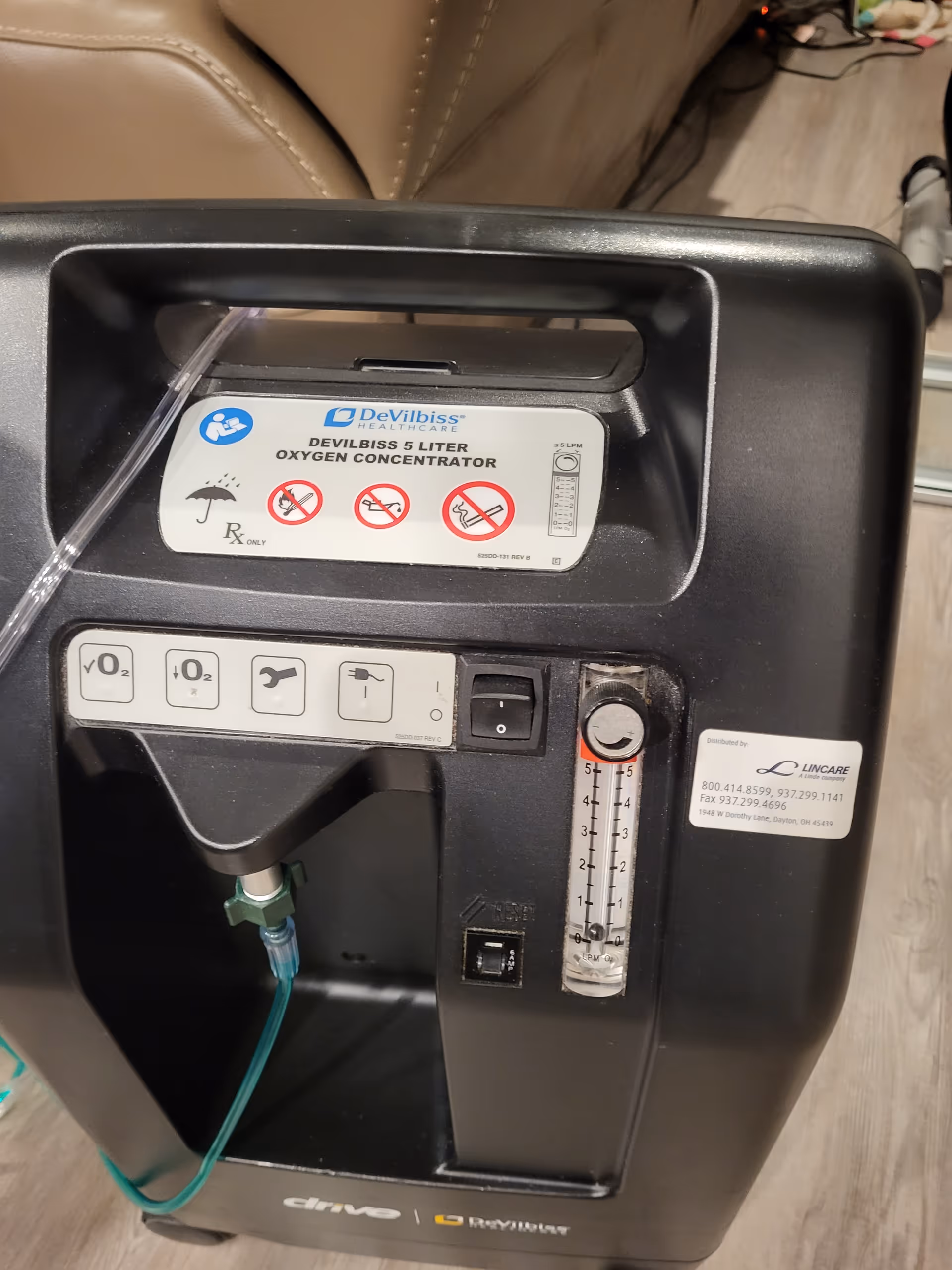 Close-up of a DeVilbiss oxygen concentrator with tubing in a senior living space.