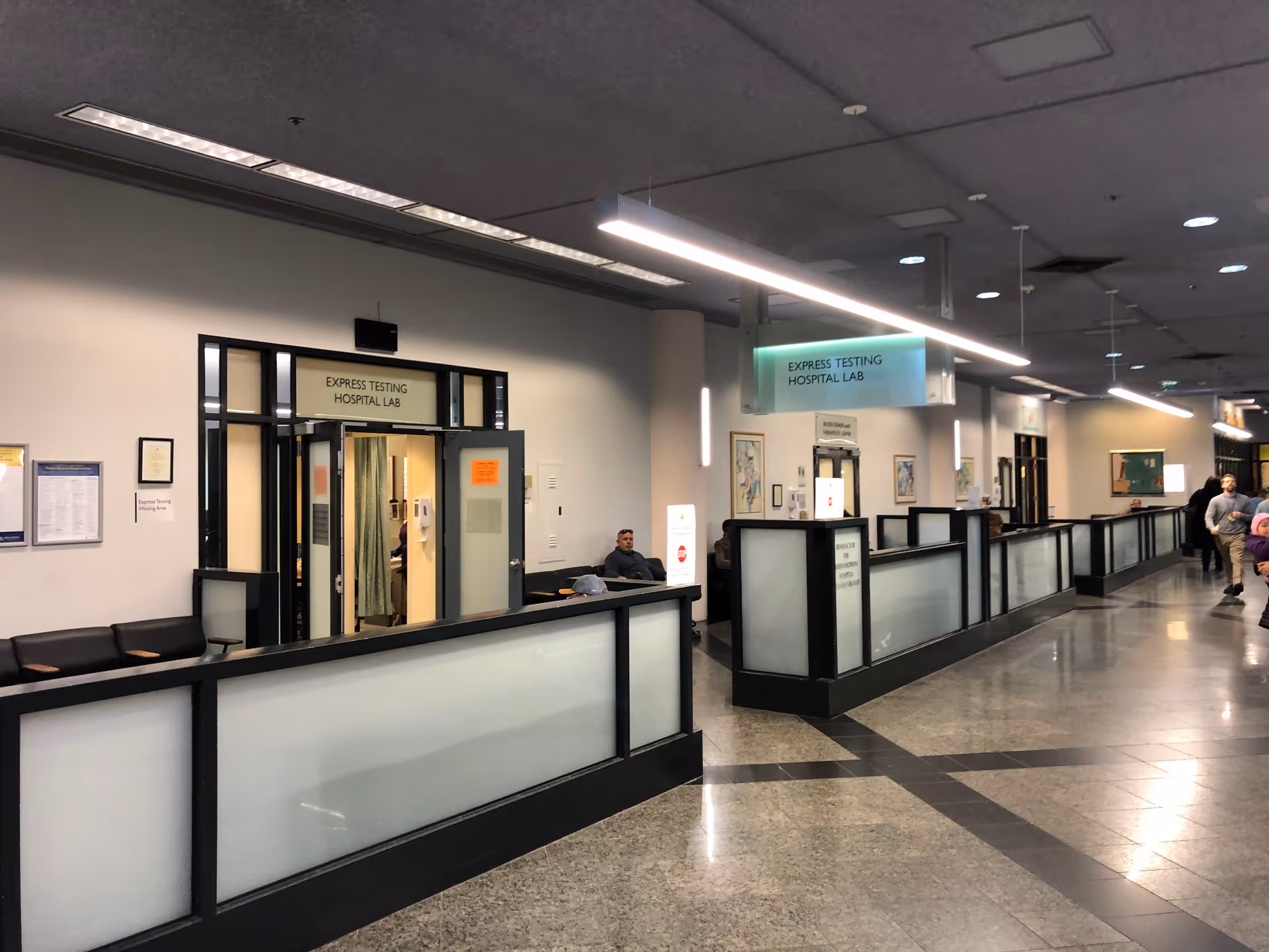 Johns Hopkins outpatient center hallway with express testing lab signage and frosted-glass barriers
