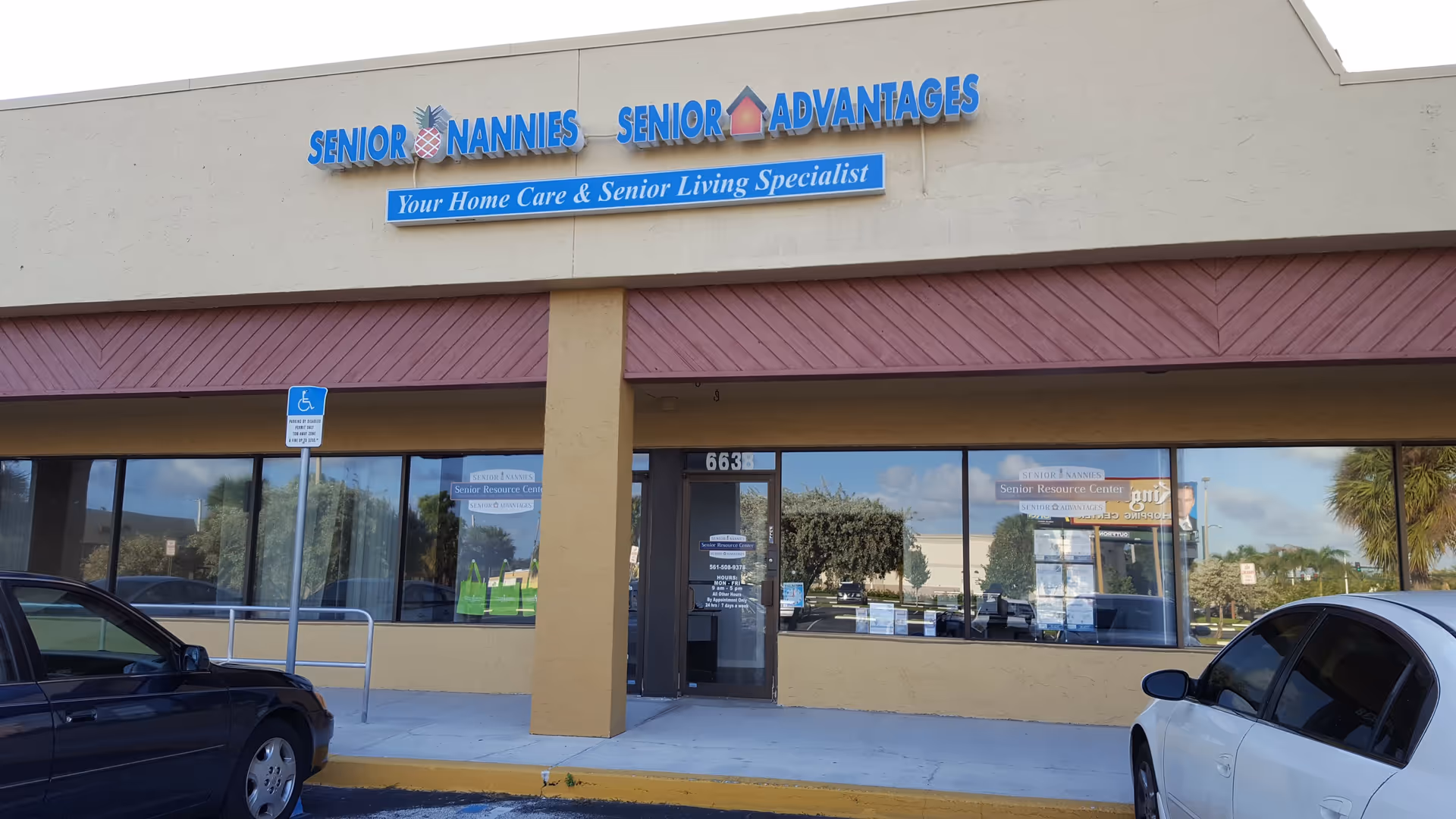 Beige storefront with blue signage for Senior Nannies and Senior Advantages, with glass windows.