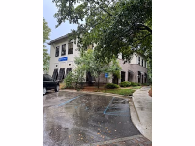 Exterior view of BAYADA Assistive Care building with trees and parking.