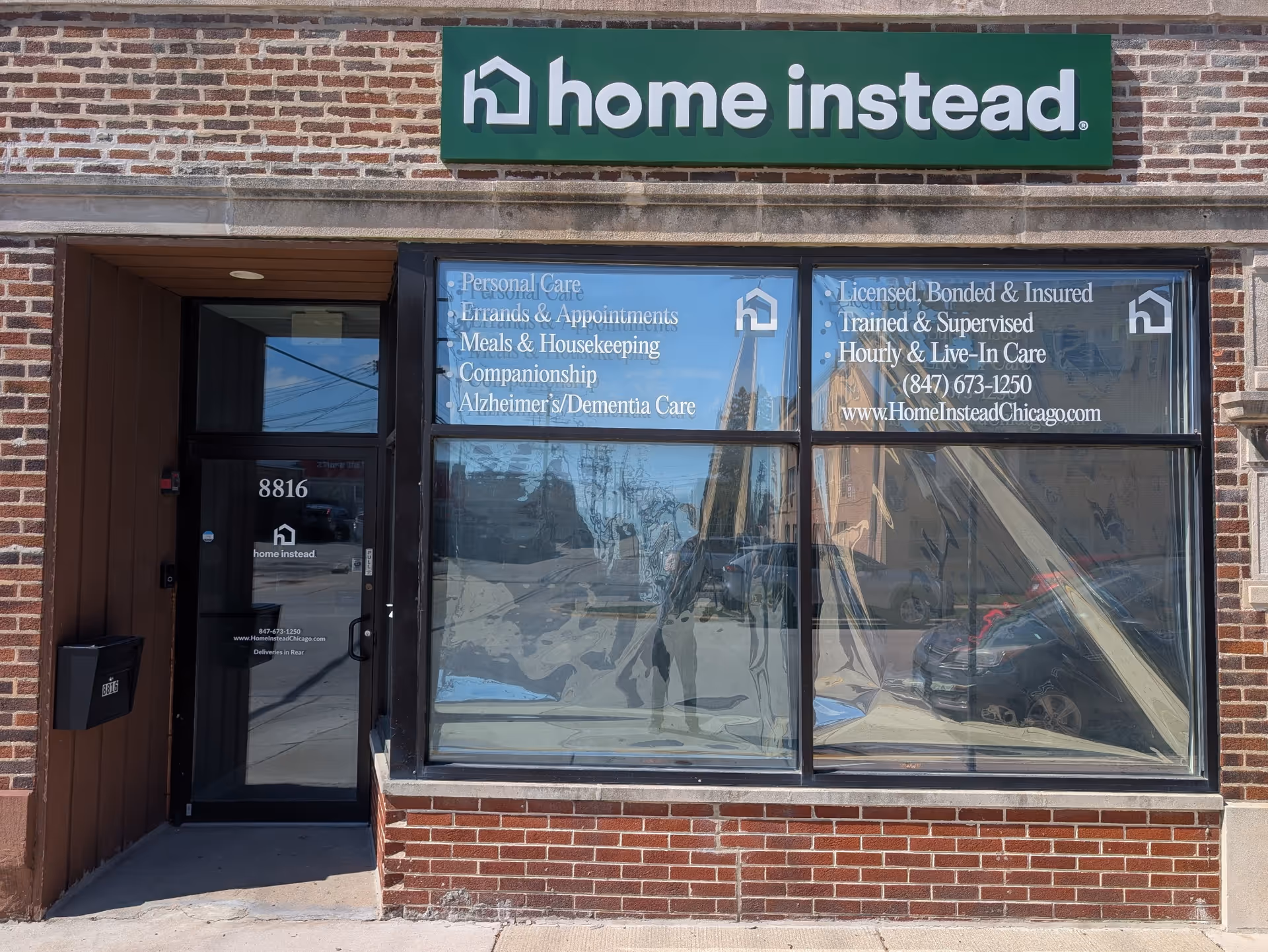 Brick storefront with Home Instead sign and large service window display