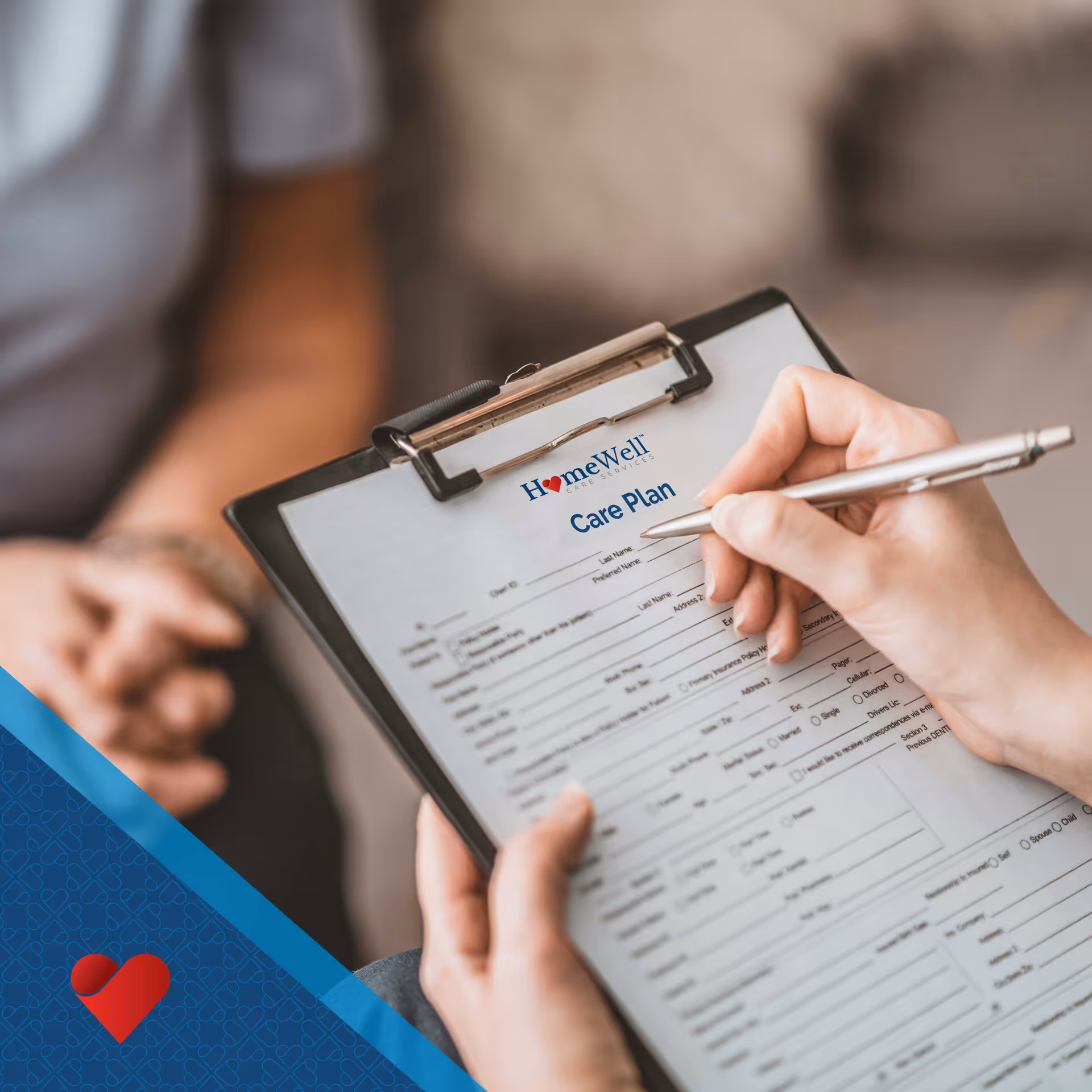 Close-up of a caregiver writing on a HomeWell Care Plan form on a clipboard.