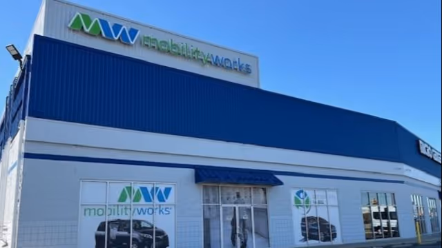 Exterior view of MobilityWorks building with blue awning and signage.