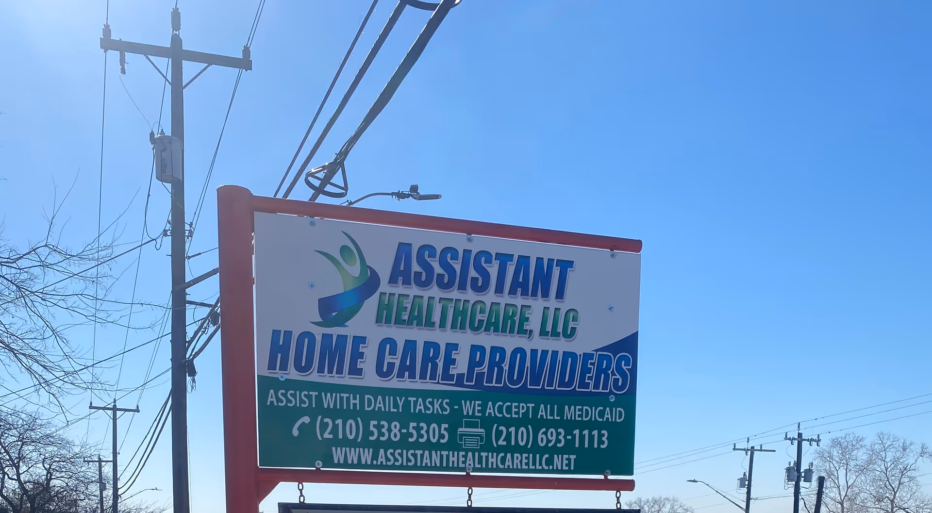 Large outdoor sign for Assistant Healthcare LLC Home Care Providers against a blue sky