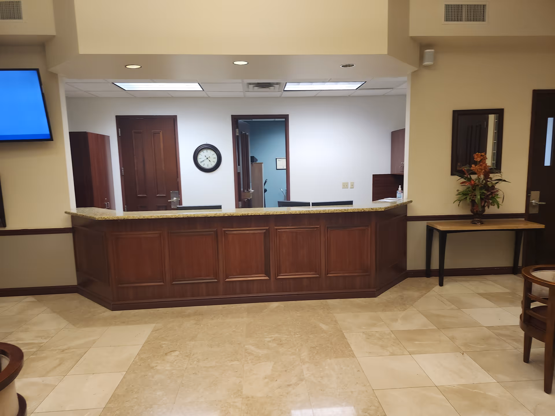Wood-paneled reception desk in a spacious lobby at Friends of the Family Home Health Care.