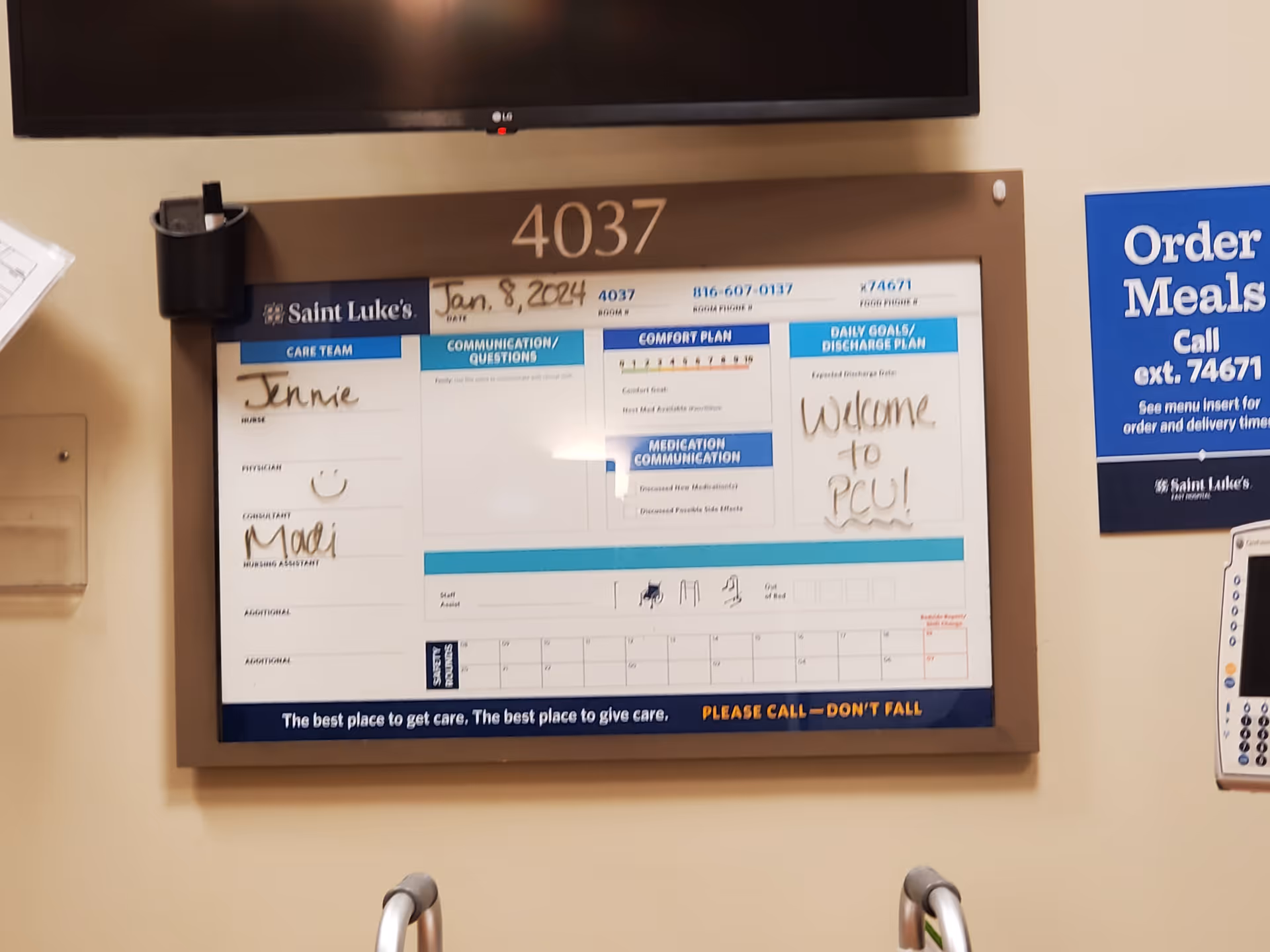 Interior hallway with a wall-mounted care board and meal sign beside room 4037.