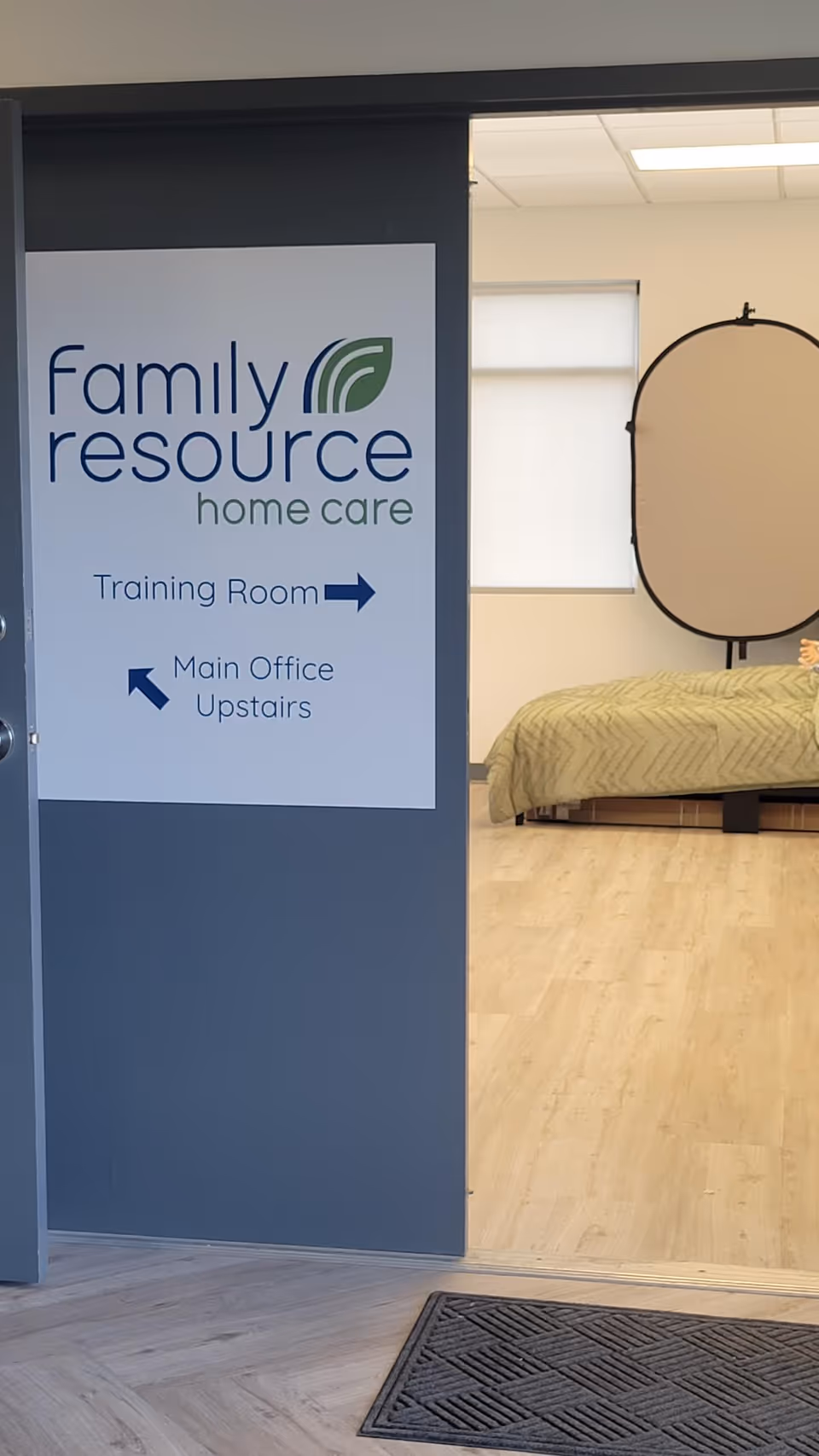 Interior of Family Resource Home Care with a sign, bed, and doorway.