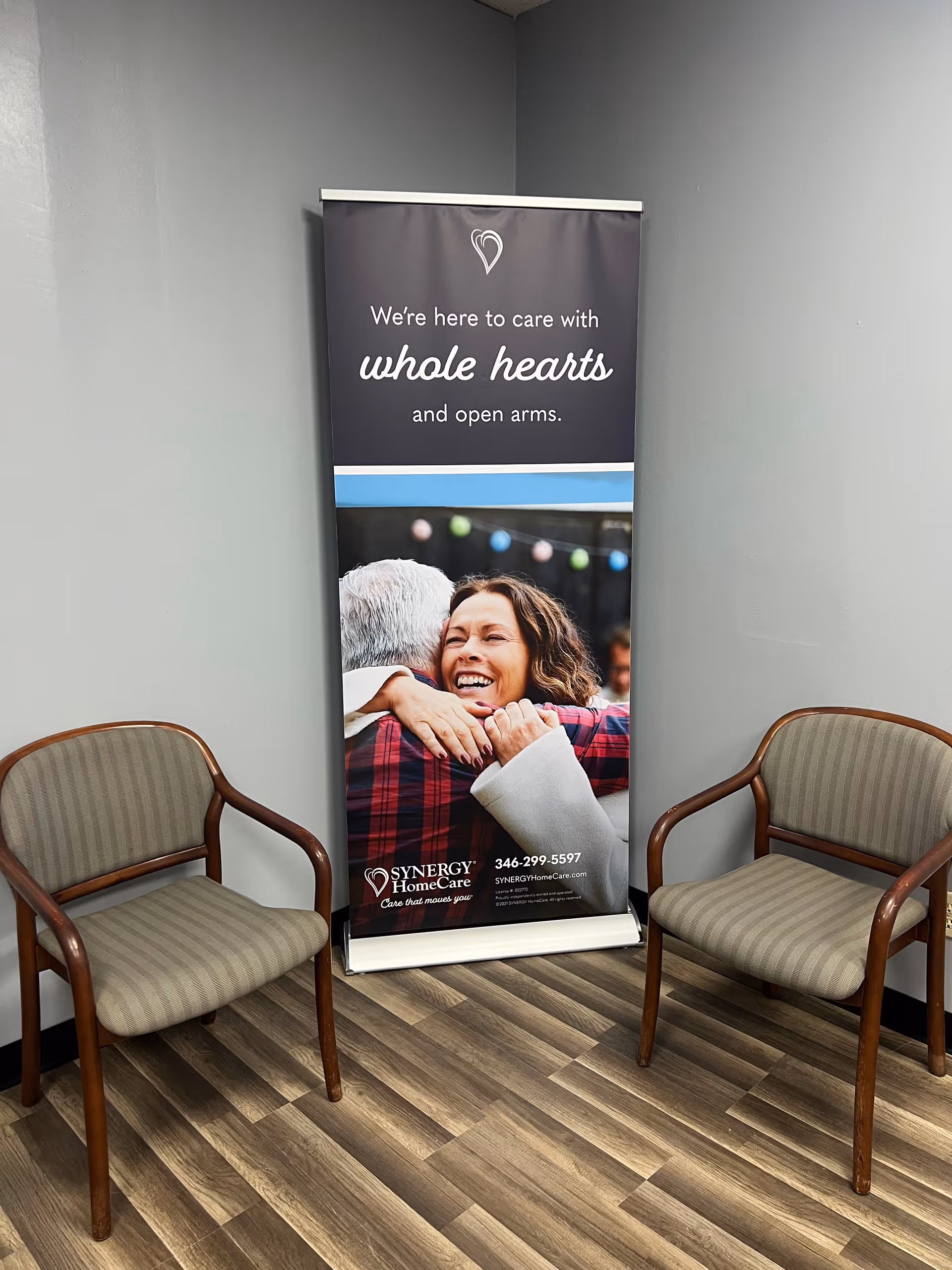 Interior waiting area featuring a Synergy HomeCare banner between two chairs.