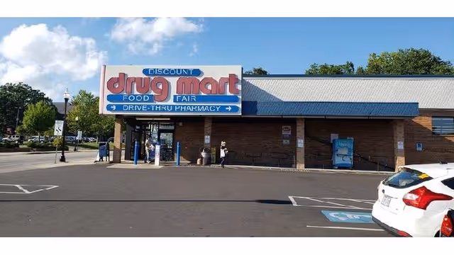 Exterior view of Discount Drug Mart storefront with sign and parking lot