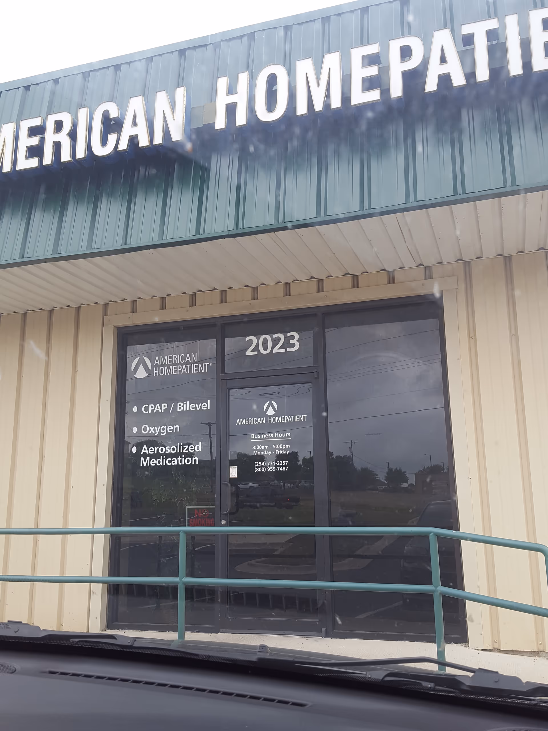 Exterior view of American HomePatient storefront with glass doors and signage.
