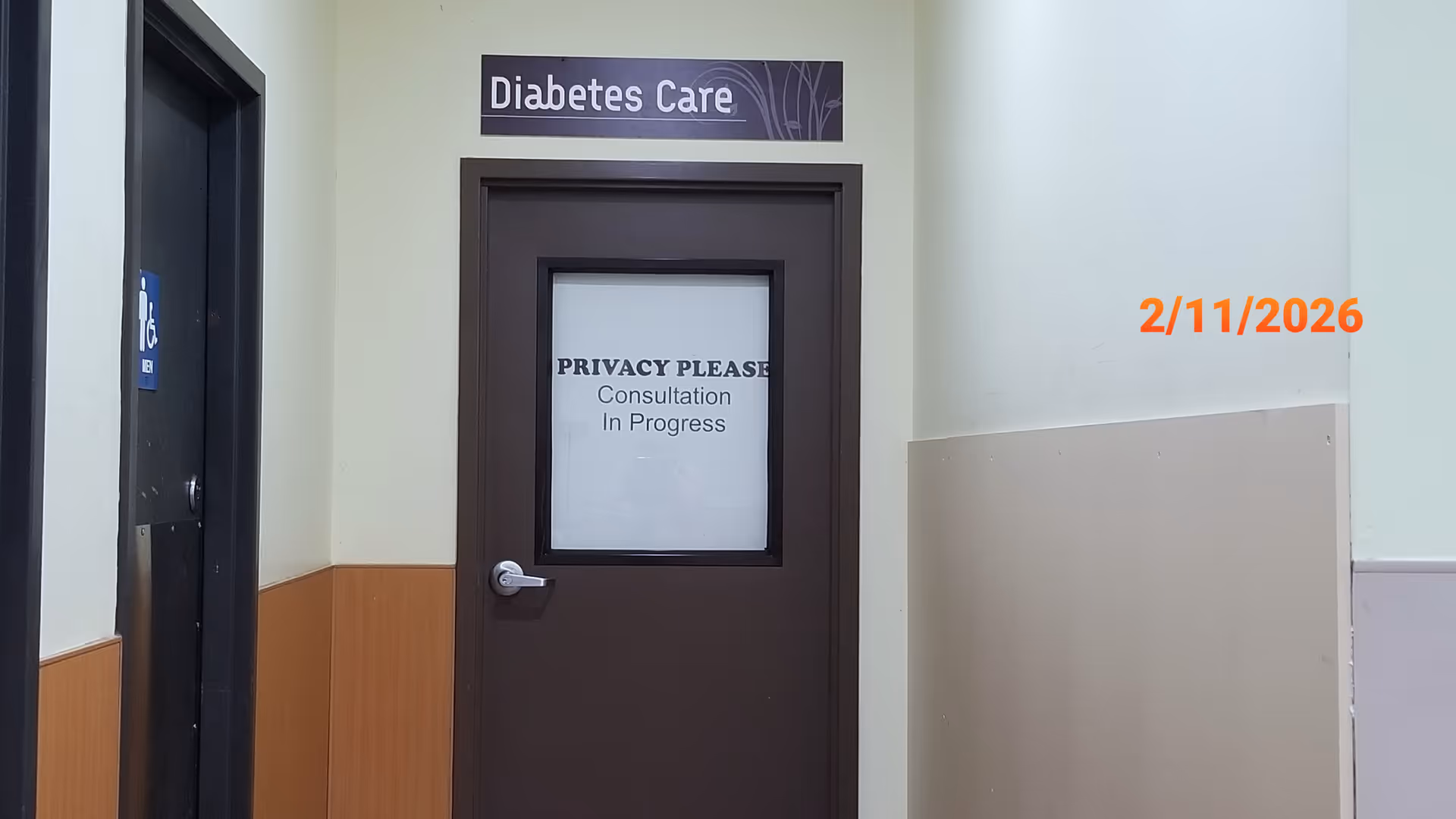 Interior hallway with a Diabetes Care door, privacy sign, and orange date on wall.