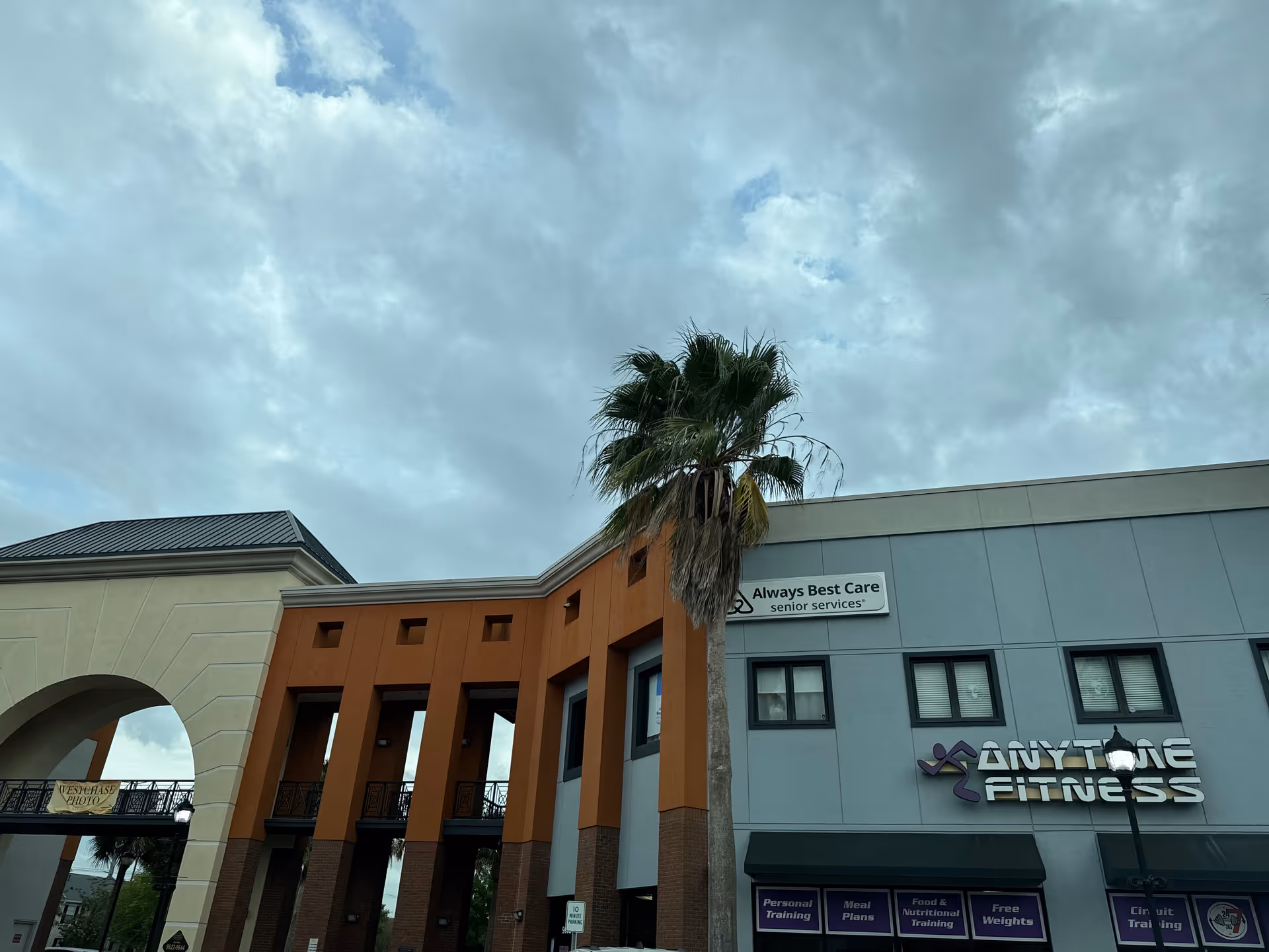 Exterior view of a mixed-use building with Always Best Care Senior Services and AnyTime Fitness signage.
